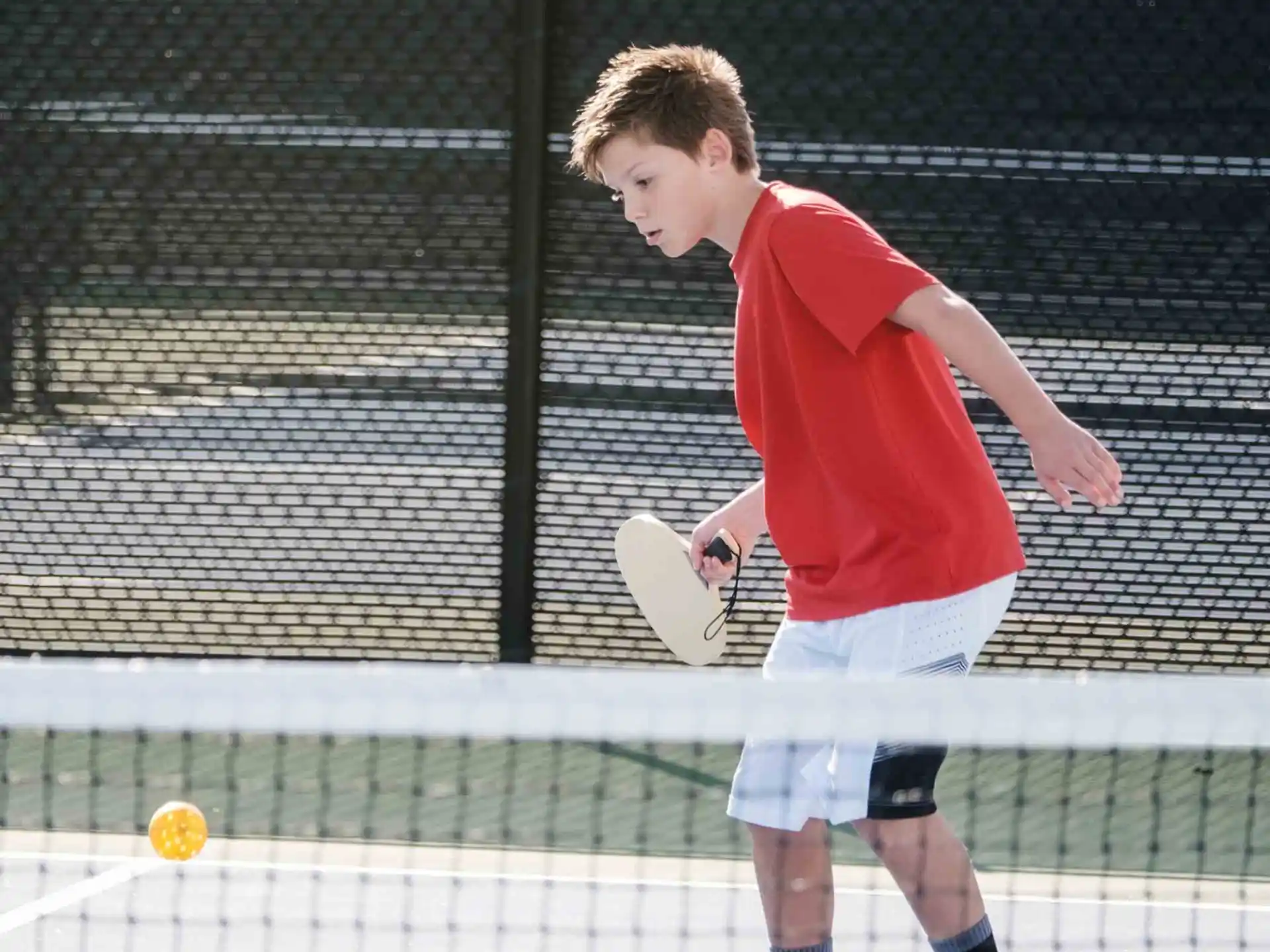 a boy playing tennis