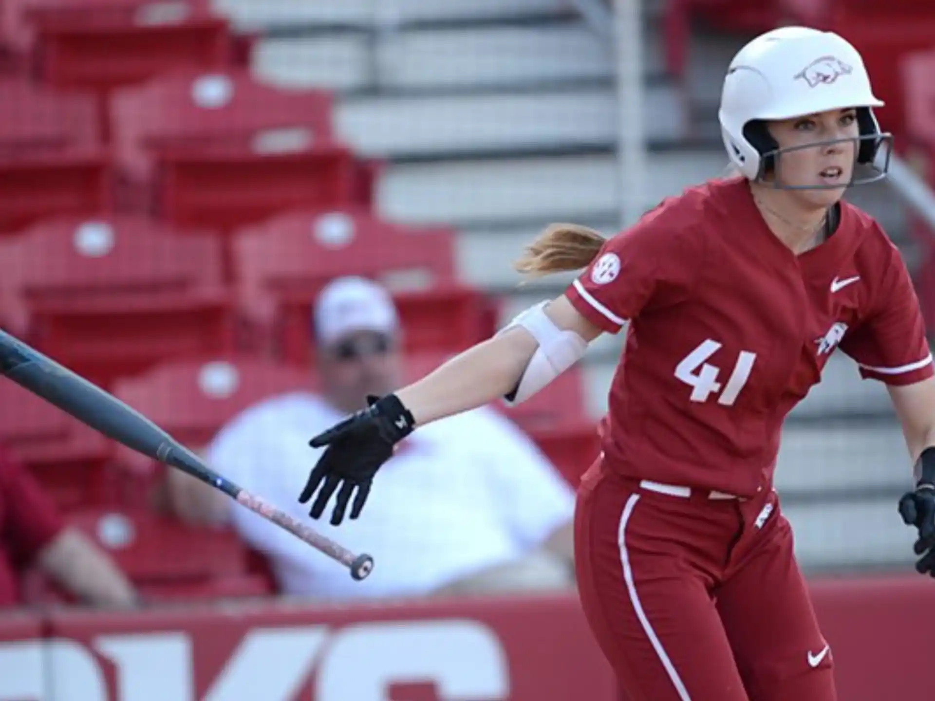 a person wearing a helmet and holding a baseball bat