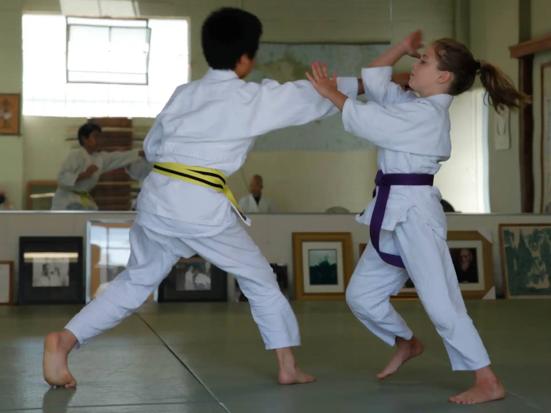 a man and a woman practicing karate