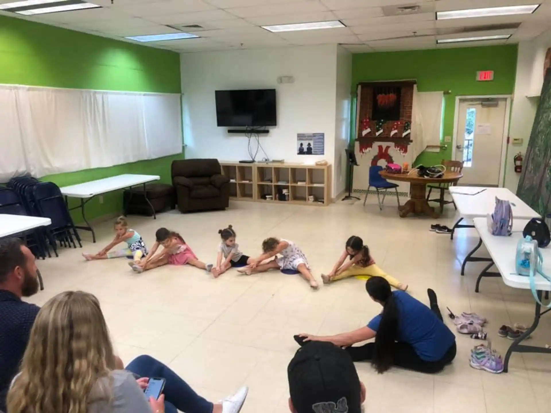a group of people sitting on the floor in a room