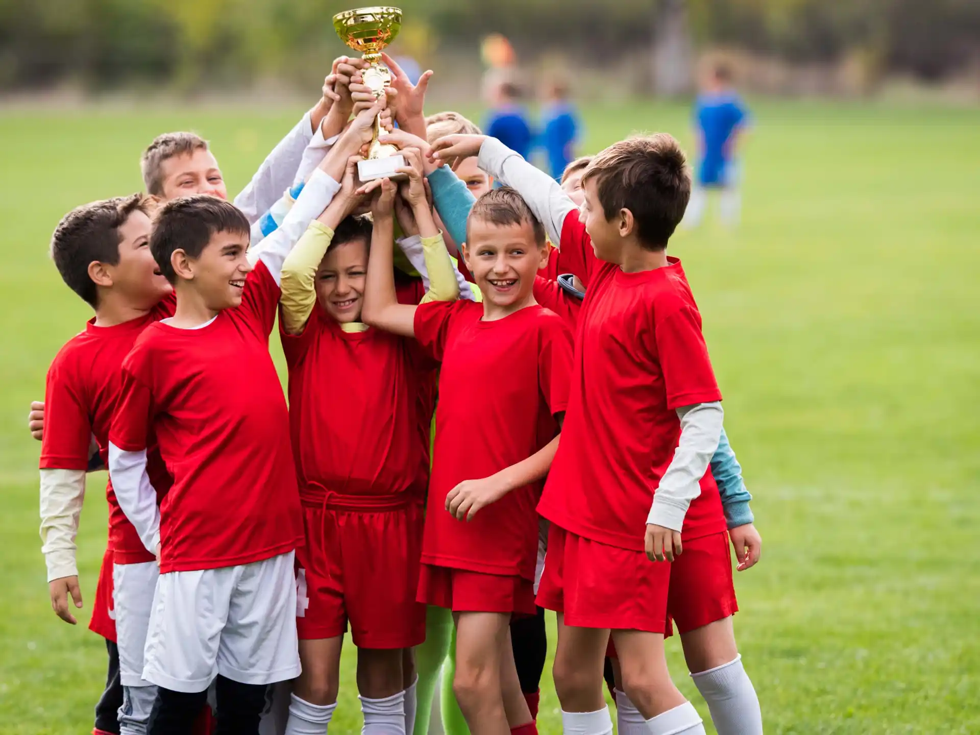 a group of boys in red uniforms
