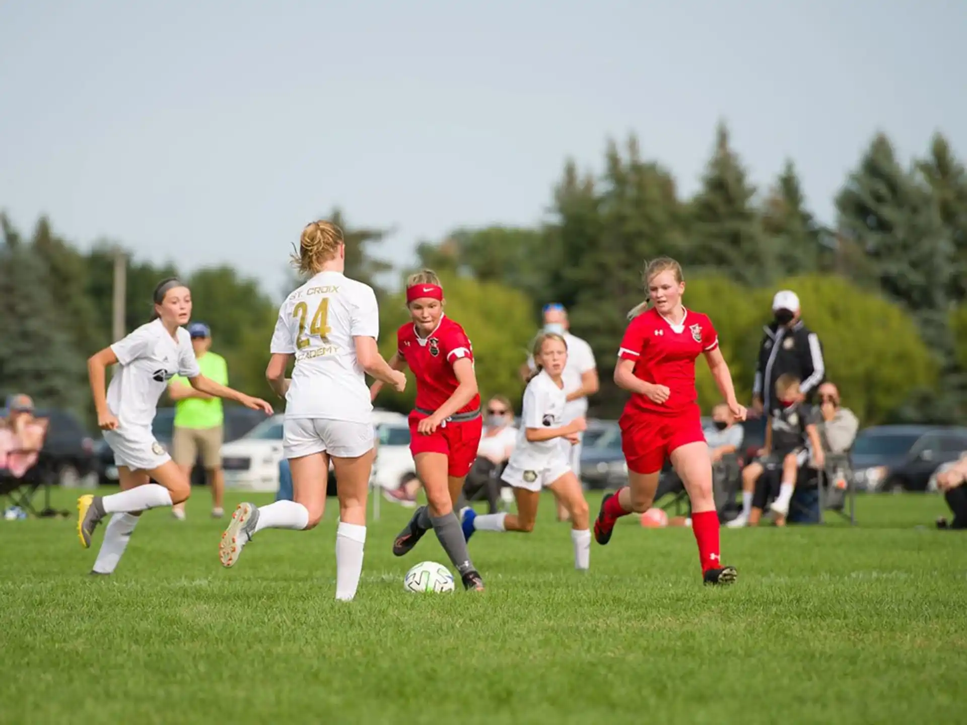 girls playing football on a field