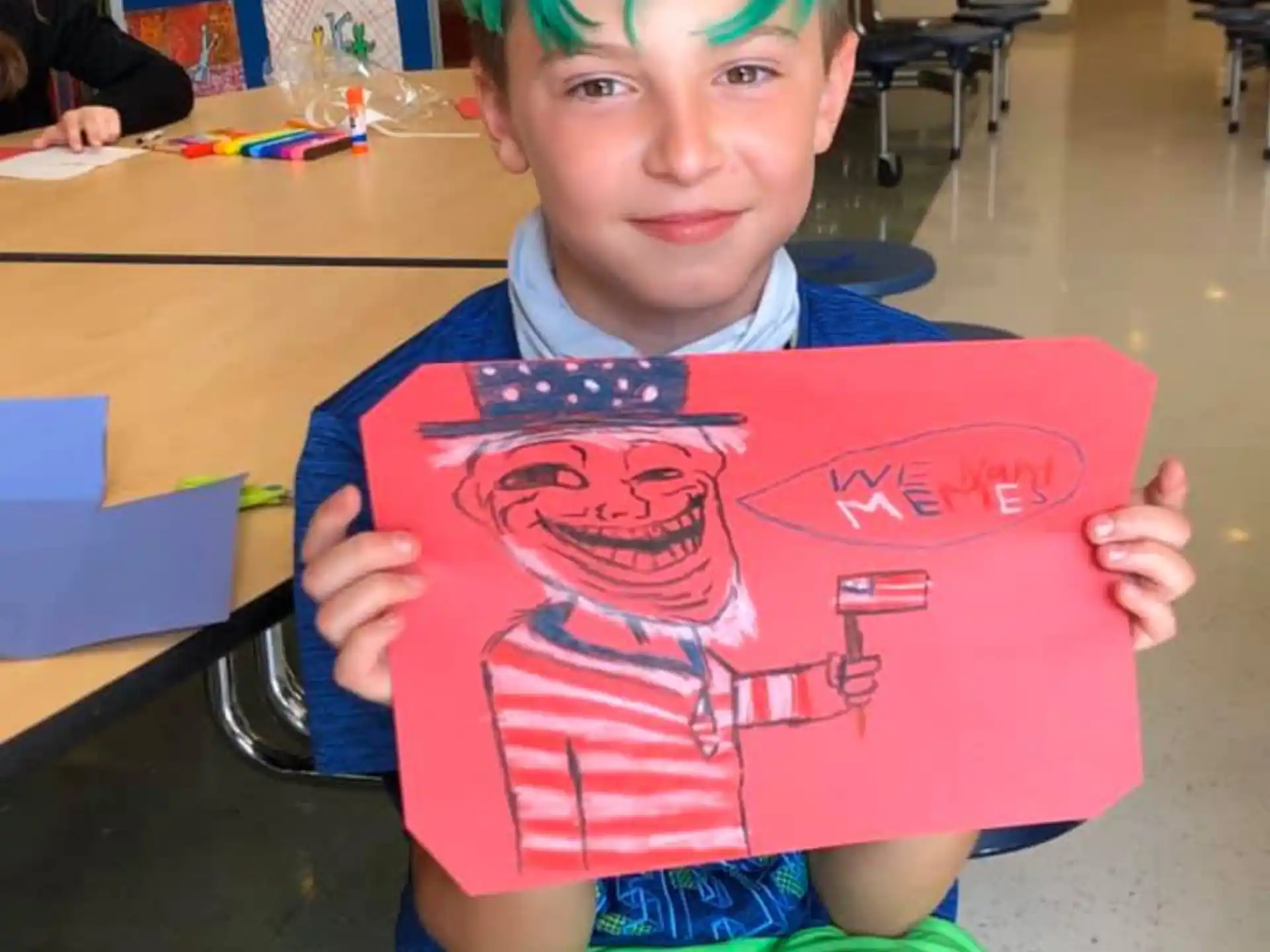 a boy with green hair holding a book in a classroom
