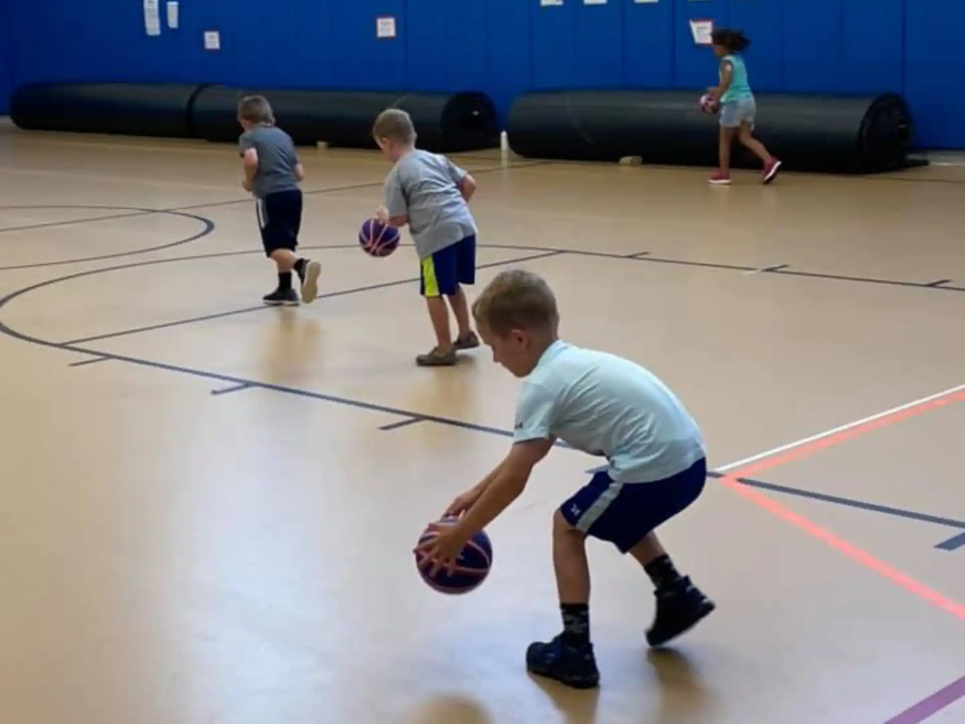 a group of kids playing basketball