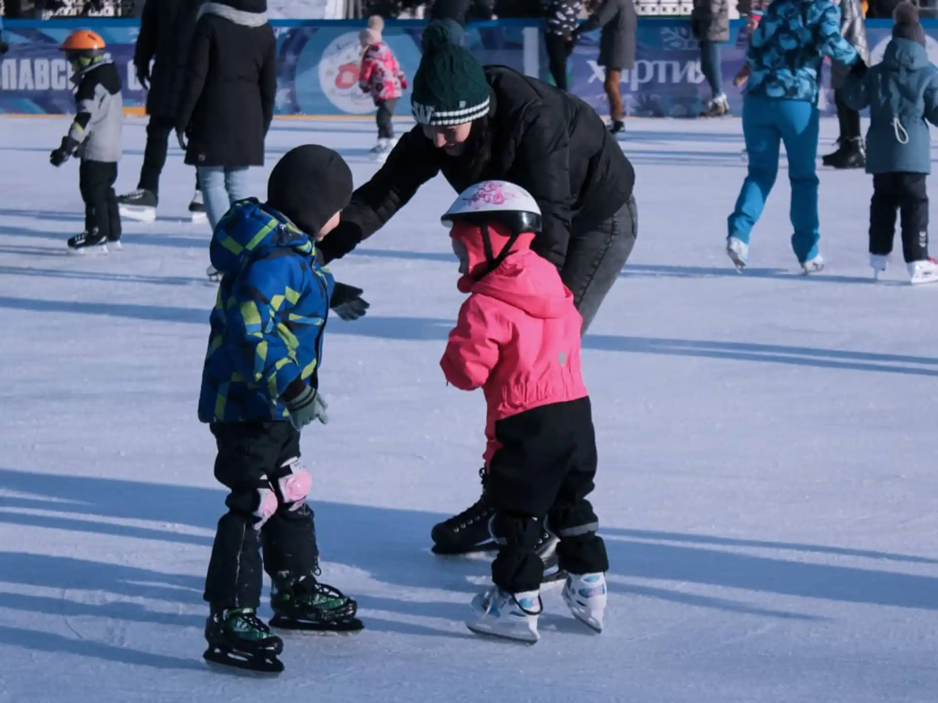 a person and two children ice skating
