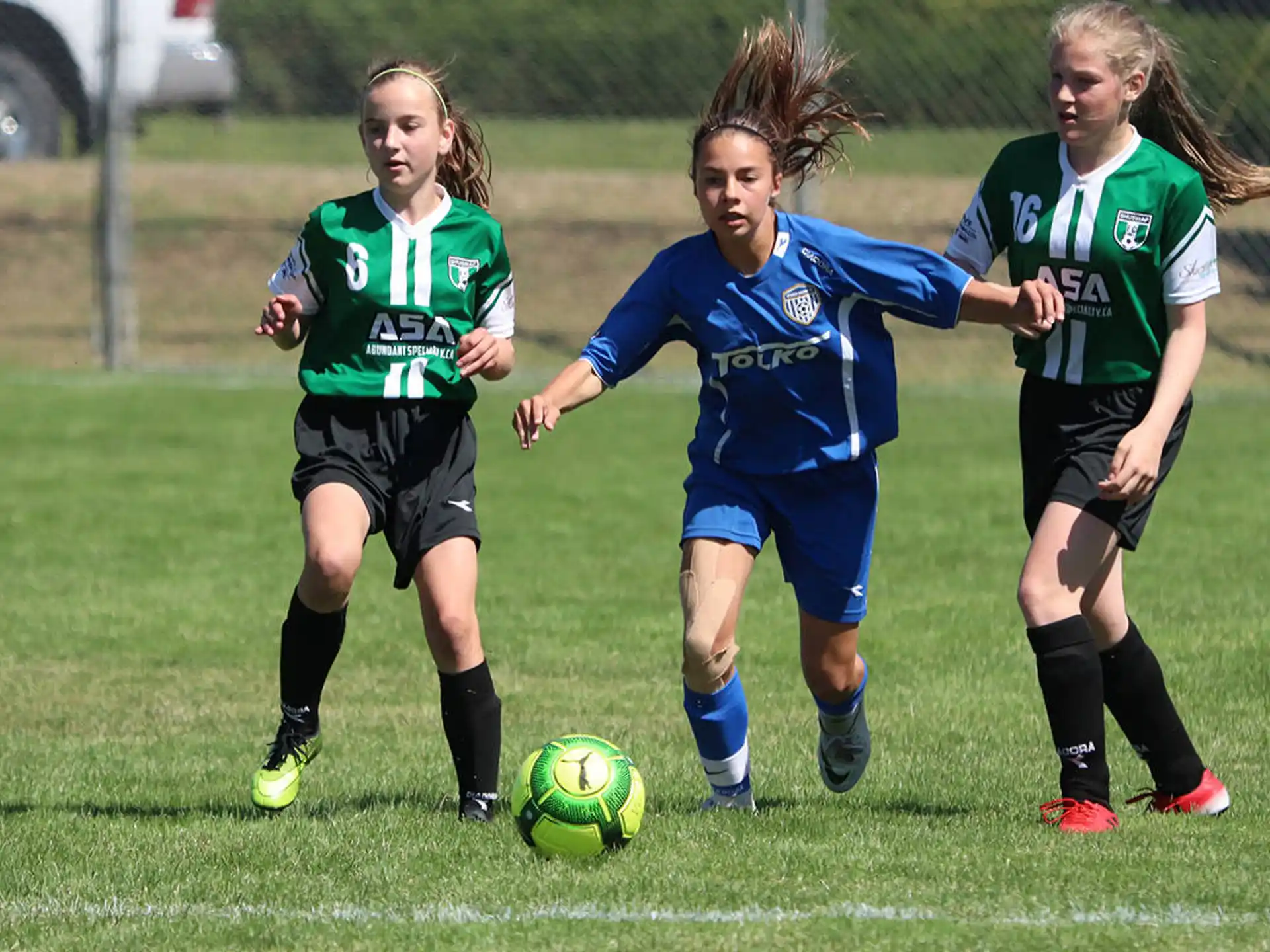girls playing football on a field