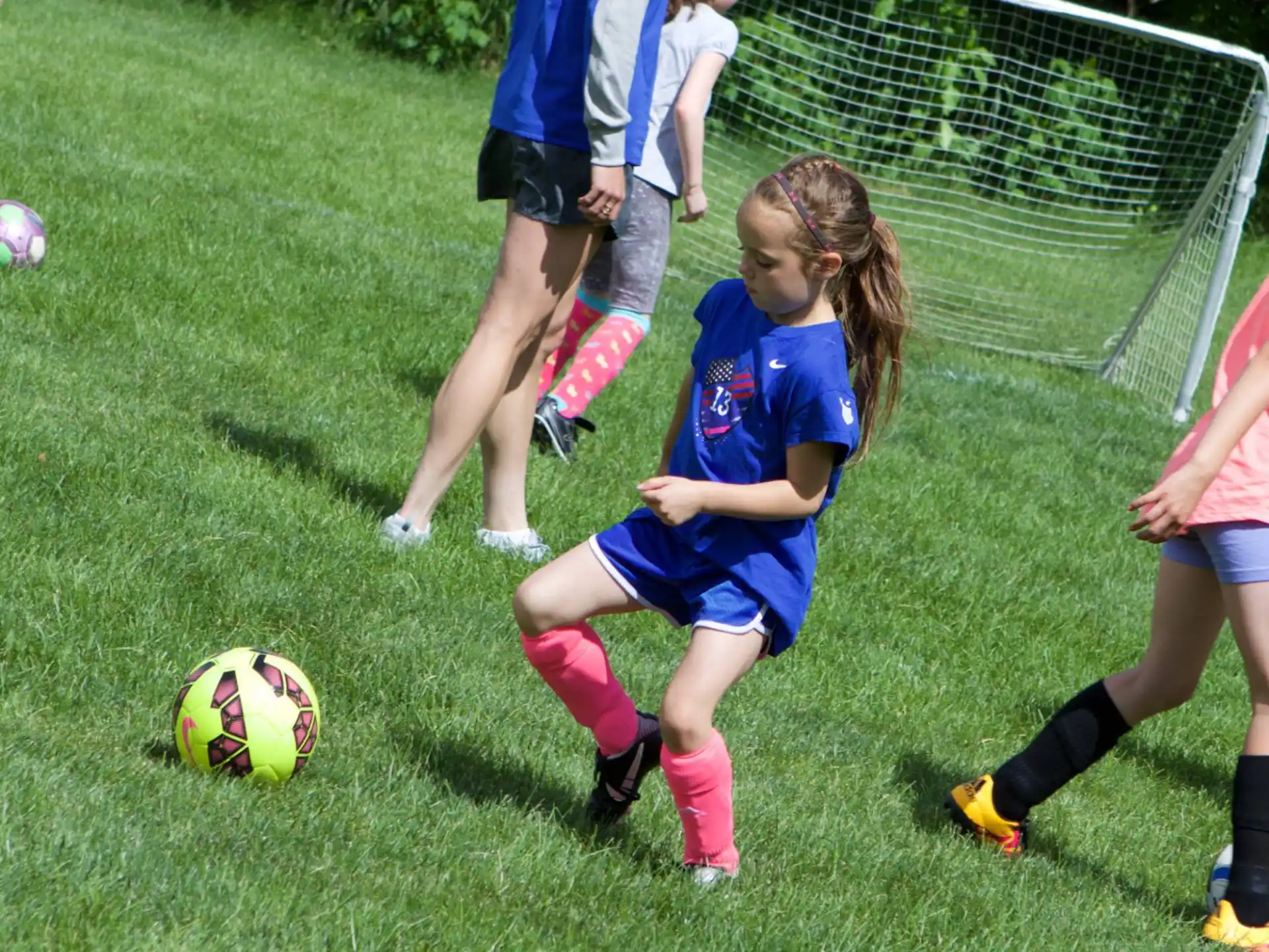 girls playing football on a field