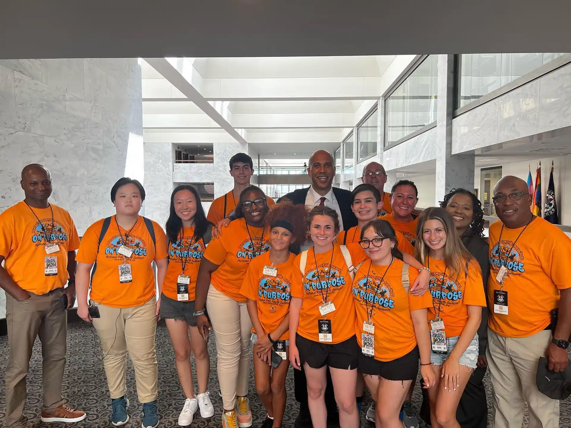 a group of people wearing orange shirts