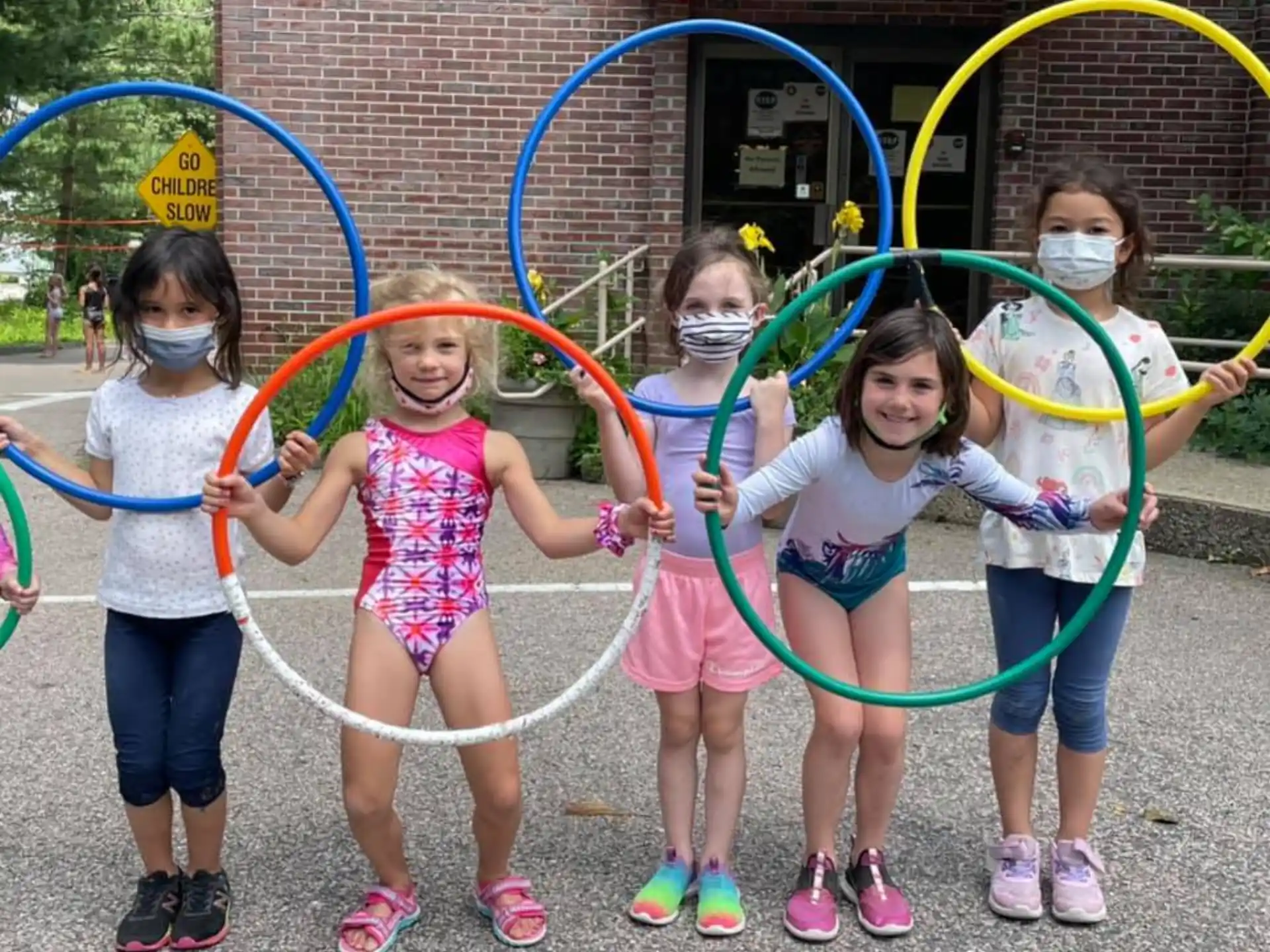 a group of girls holding bows and arrows
