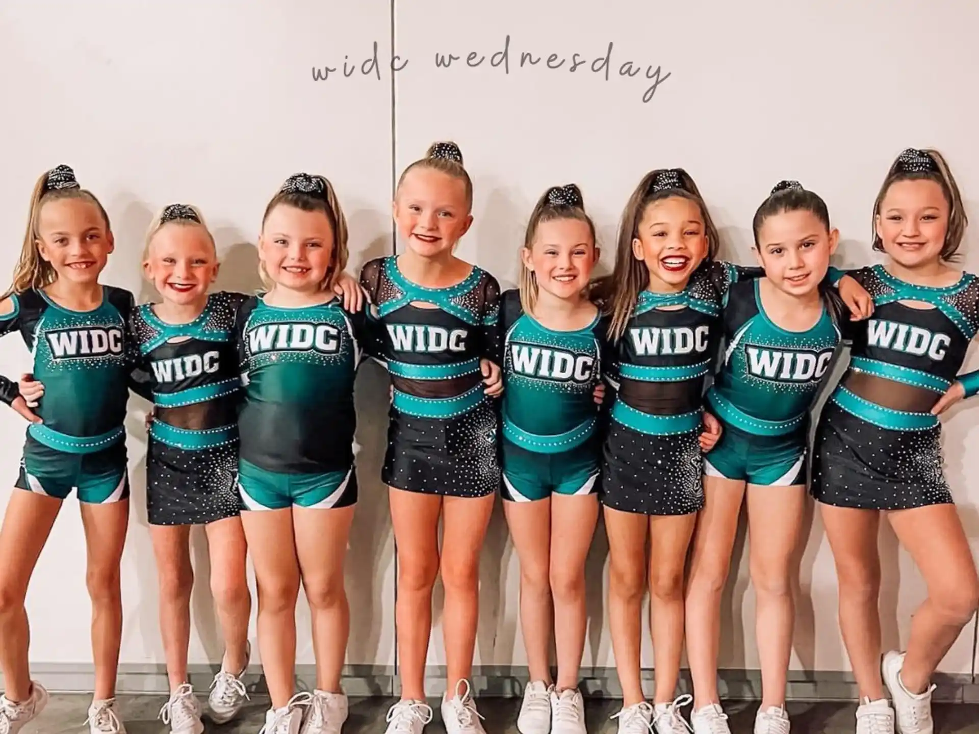 a group of girls in matching outfits