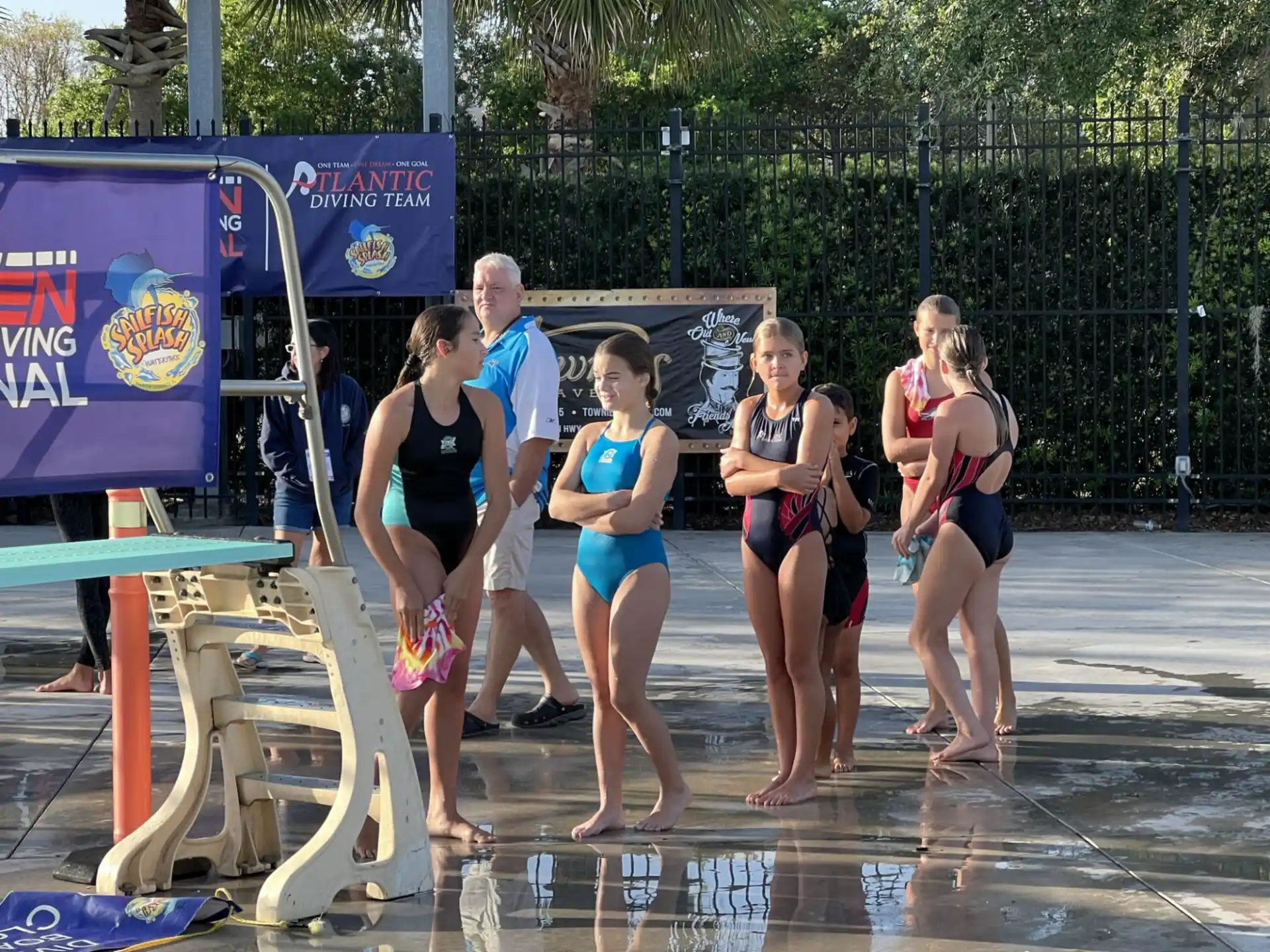 a group of people in swimsuits standing in a pool
