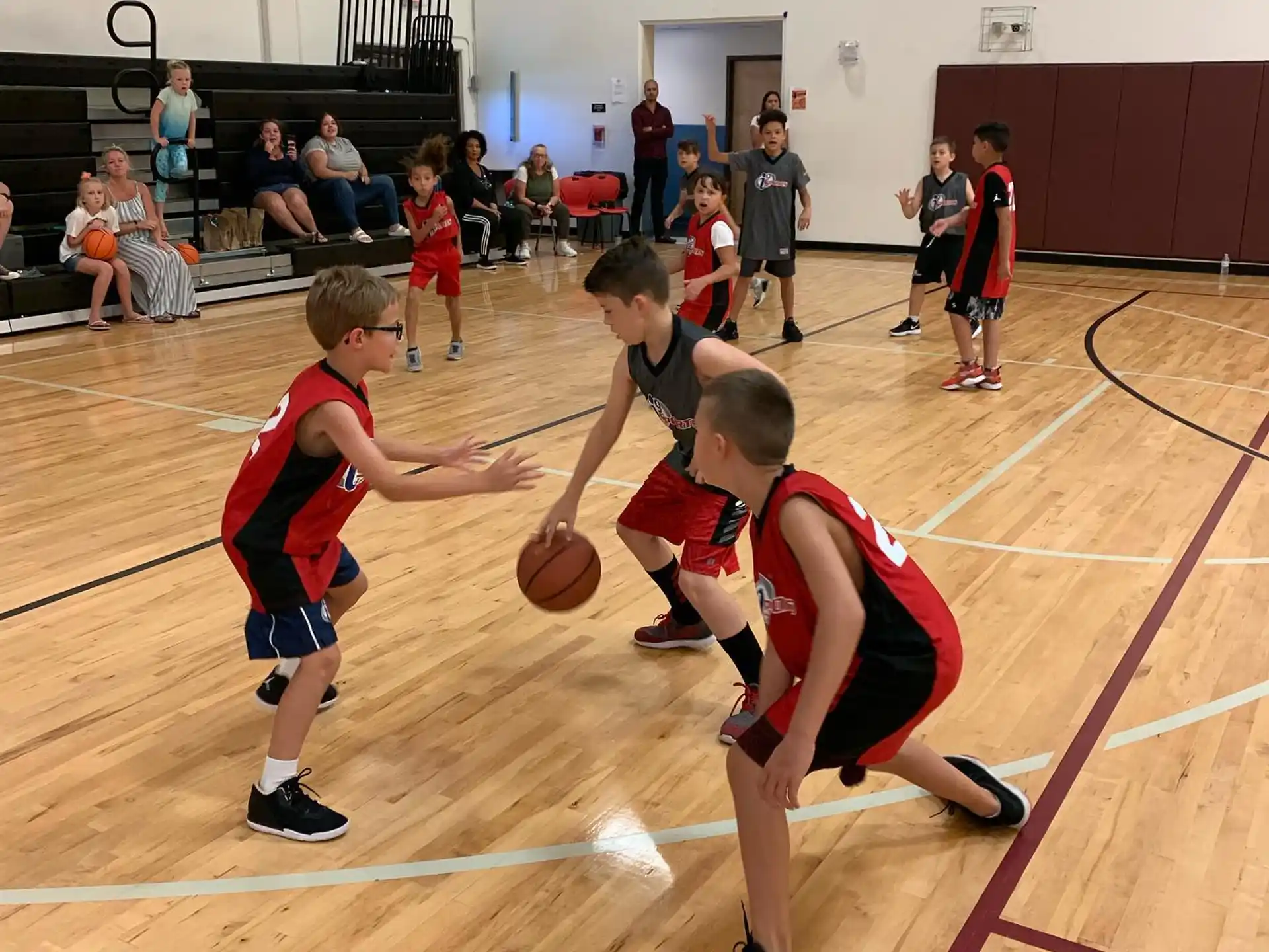 a group of kids playing basketball