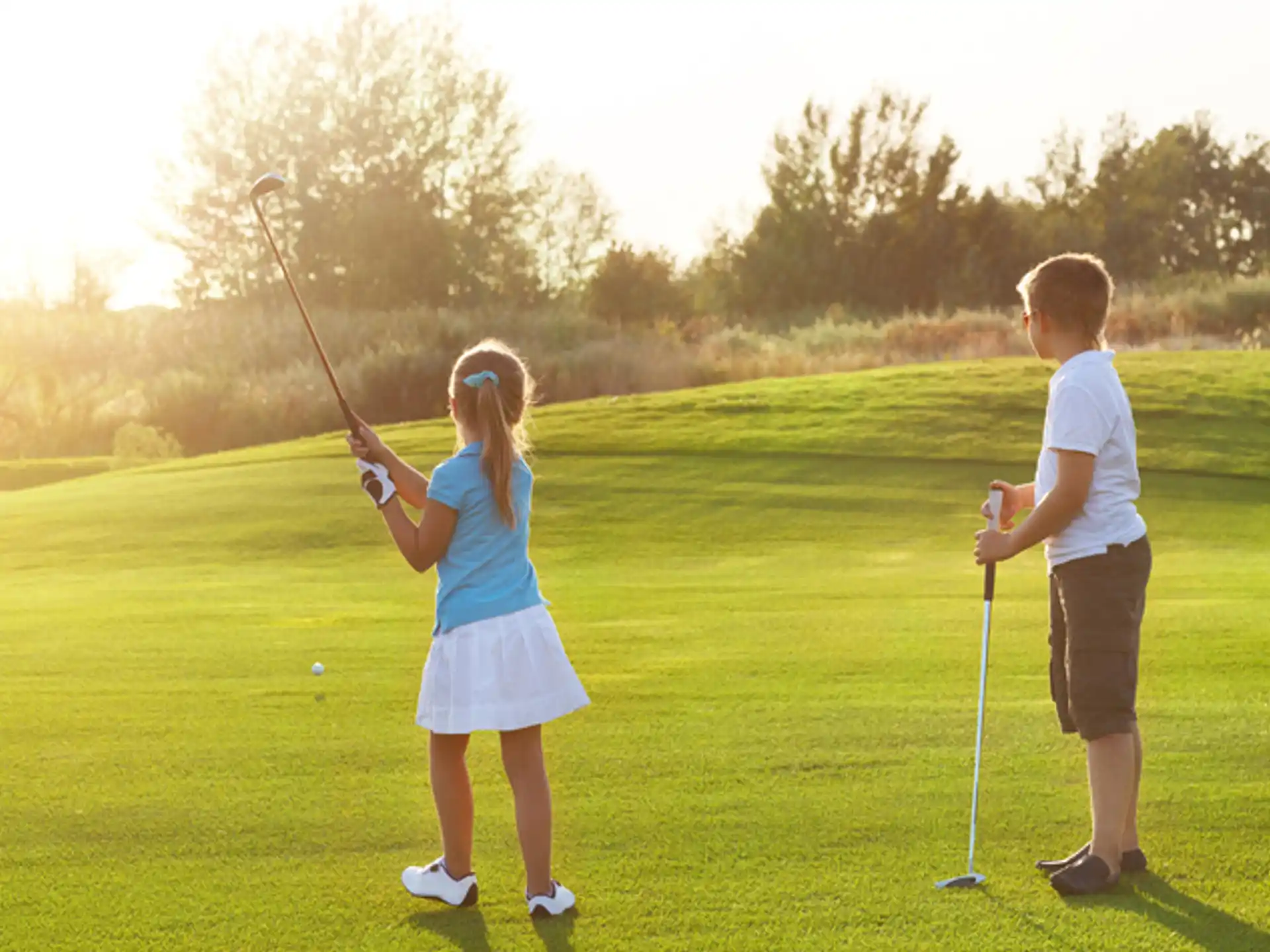 a boy and girl playing golf