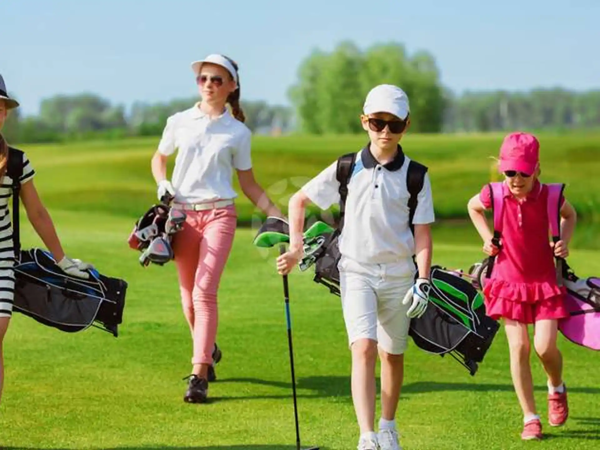 a group of people walking on a golf course