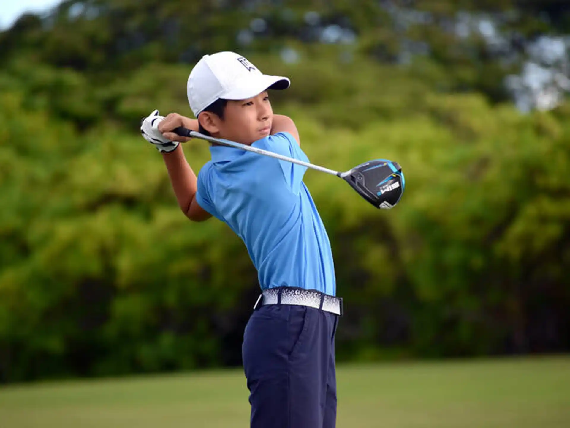 a person swinging a golf club