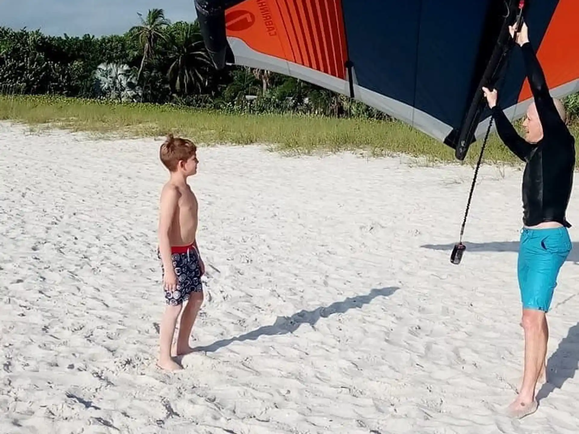 a person and a boy on a beach