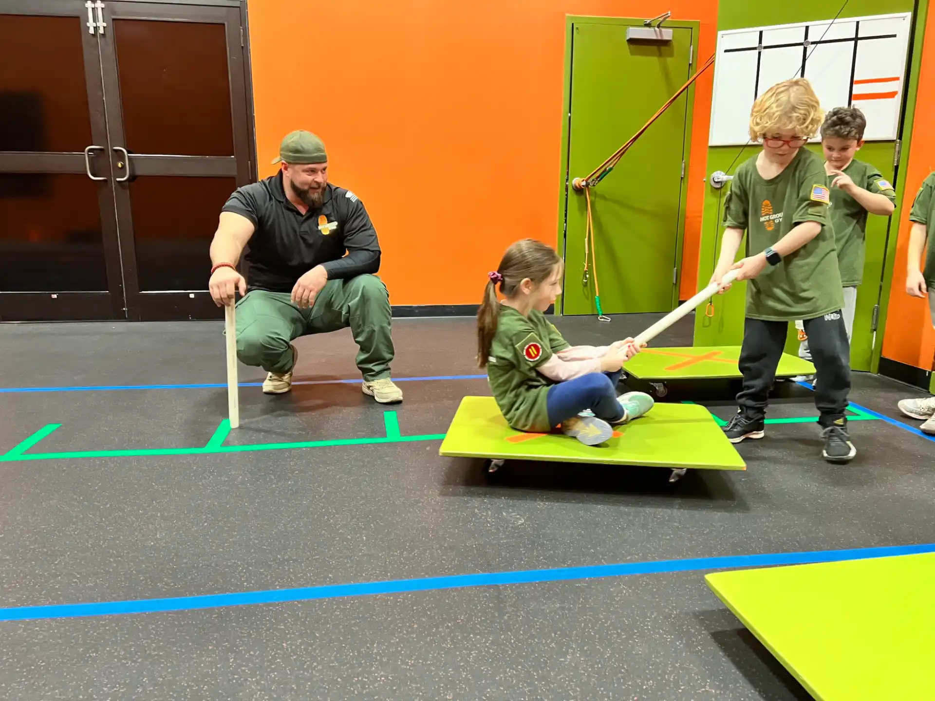 a person and kids playing on a small trampoline