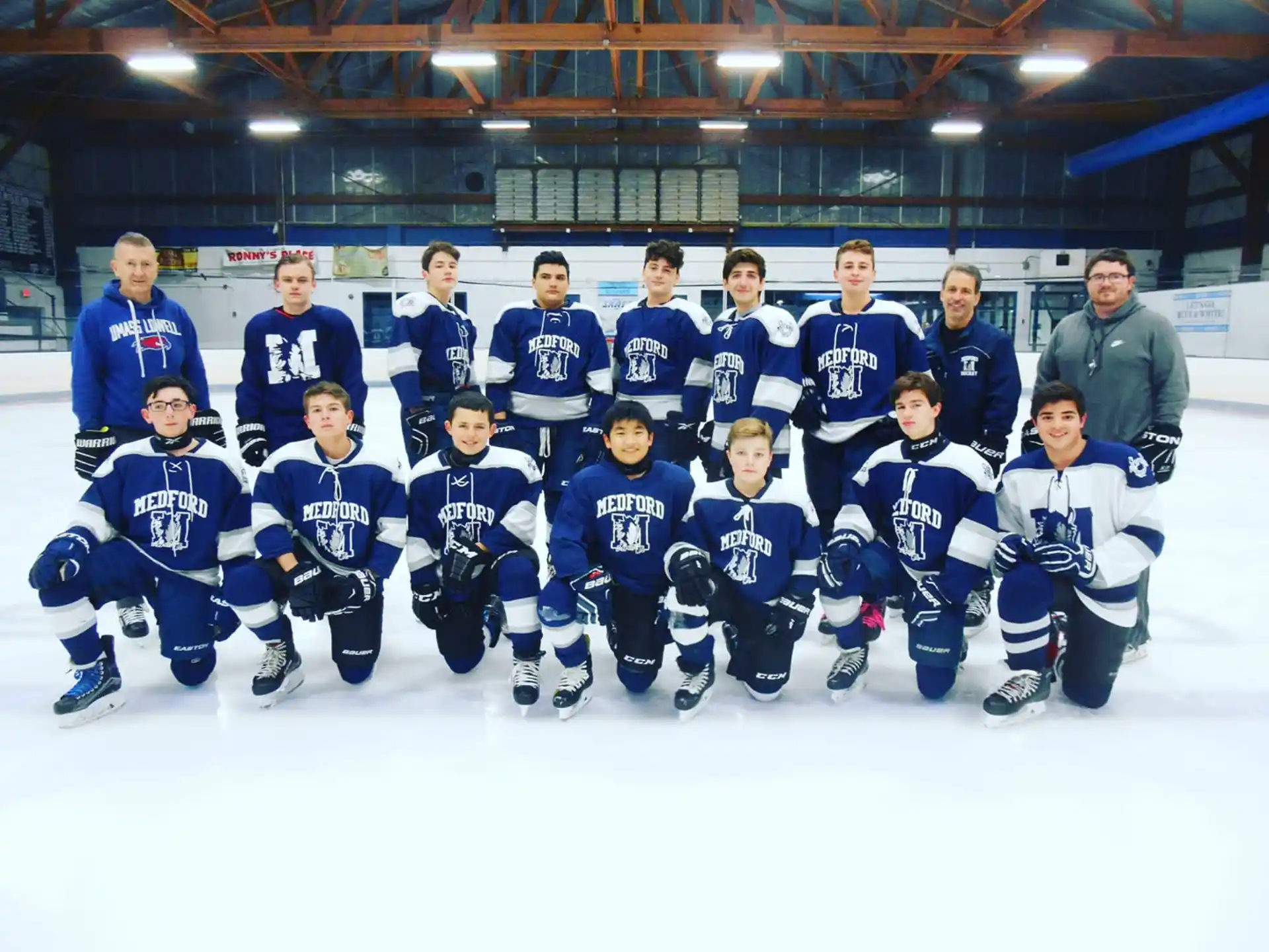 a group of hockey players posing for a photo