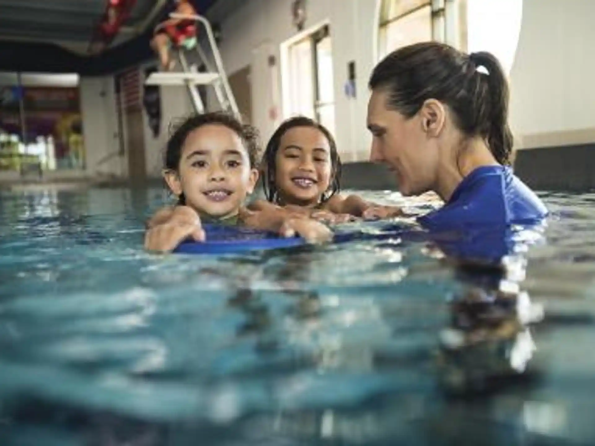 a person and two children in a pool