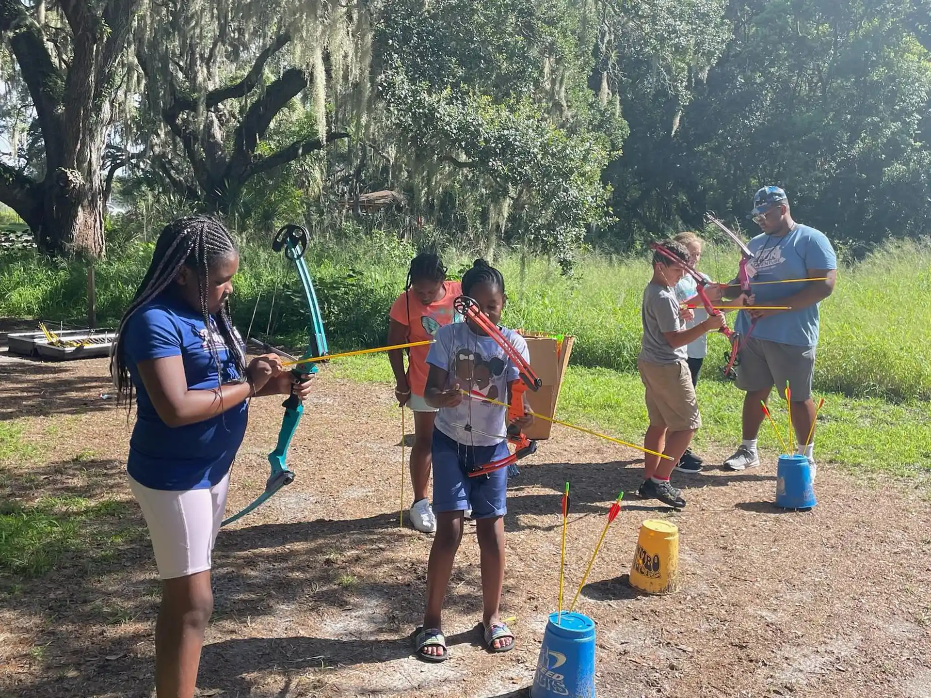 a group of people holding bows and arrows