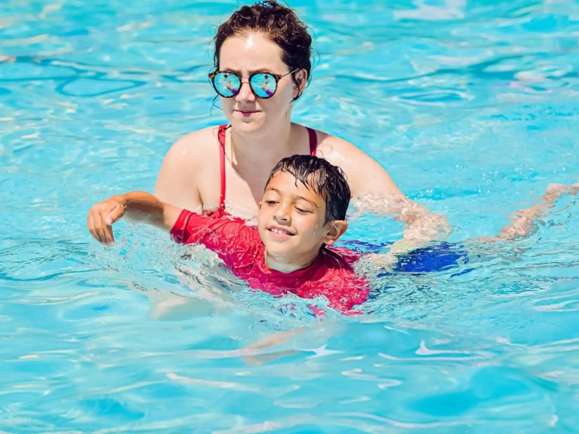 a person and a child in a pool