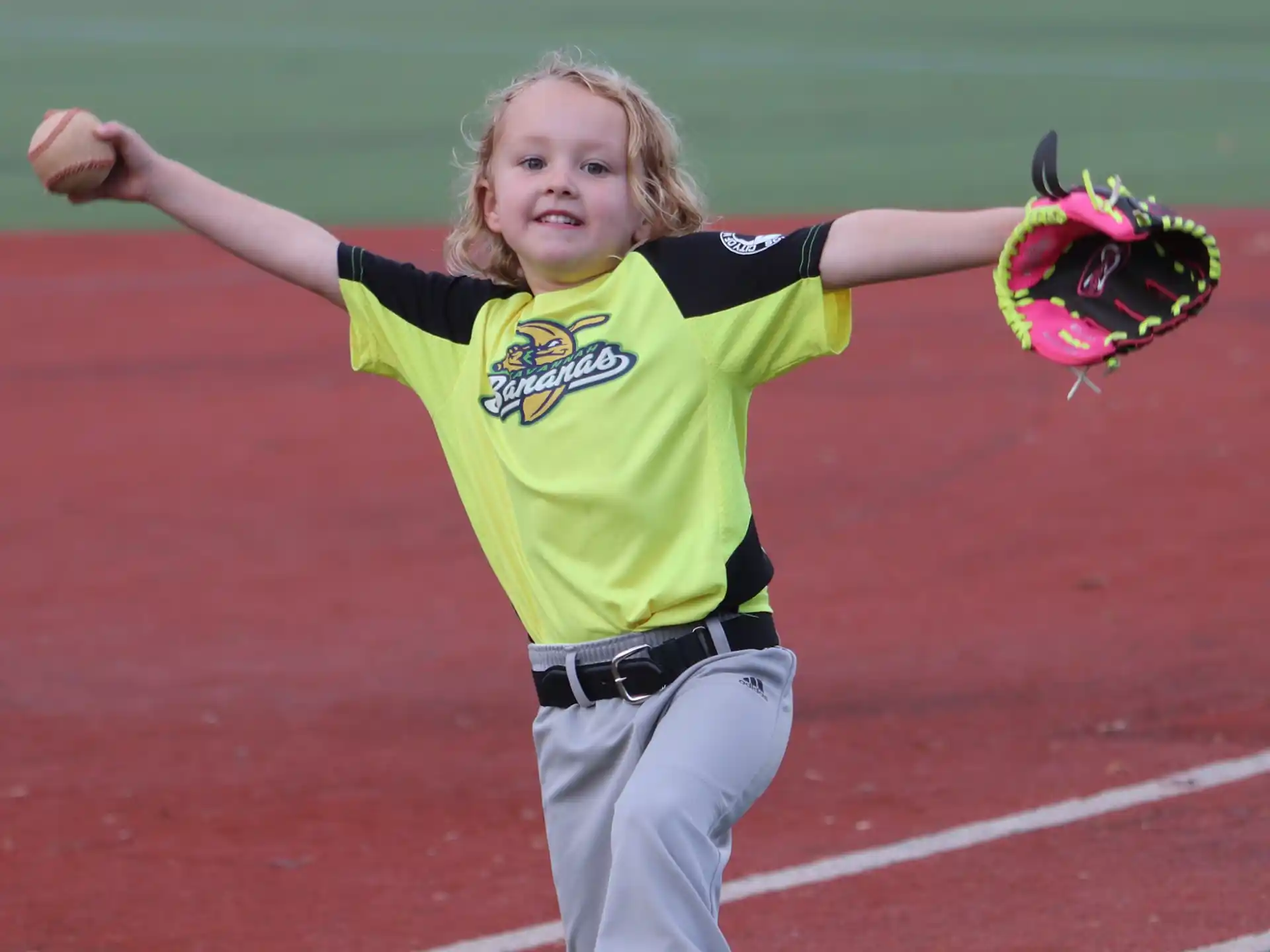 a girl catching a baseball