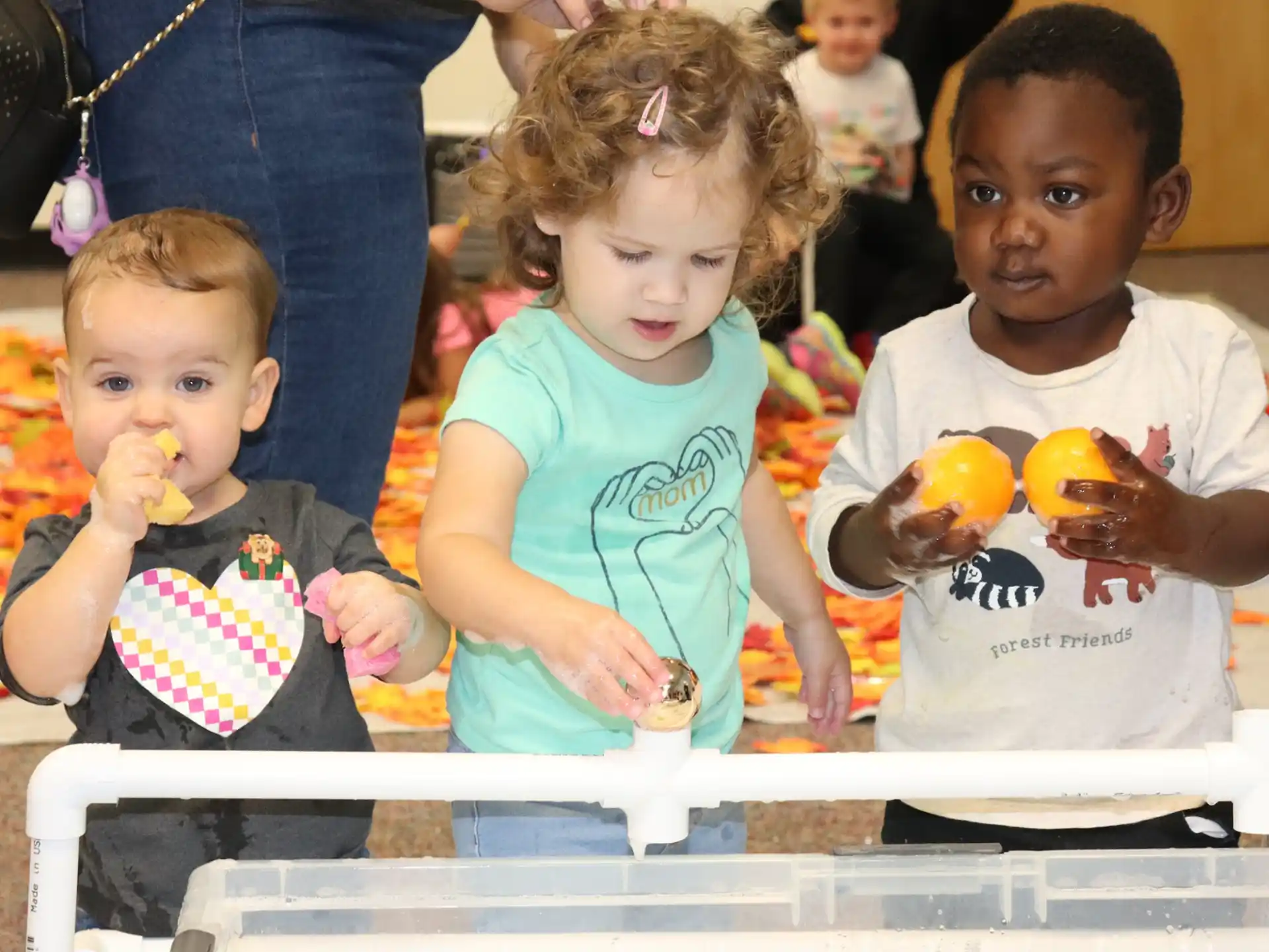 a group of children eating donuts