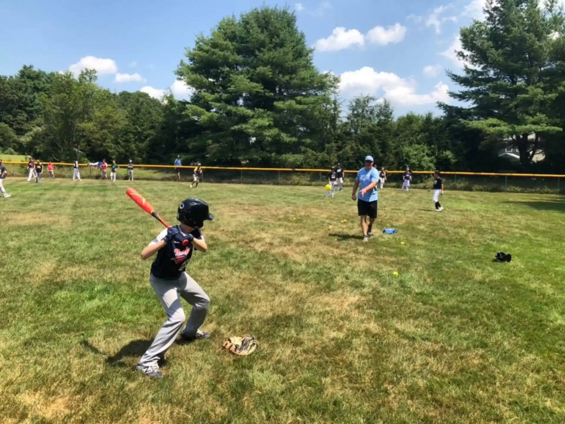 a kid swinging a baseball bat