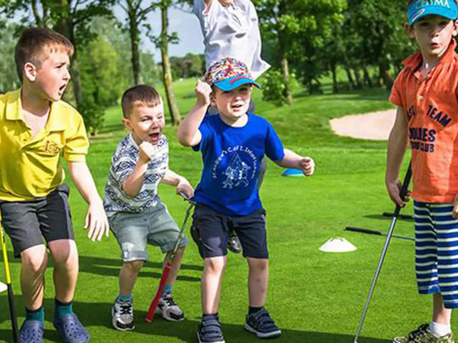 a group of boys playing golf