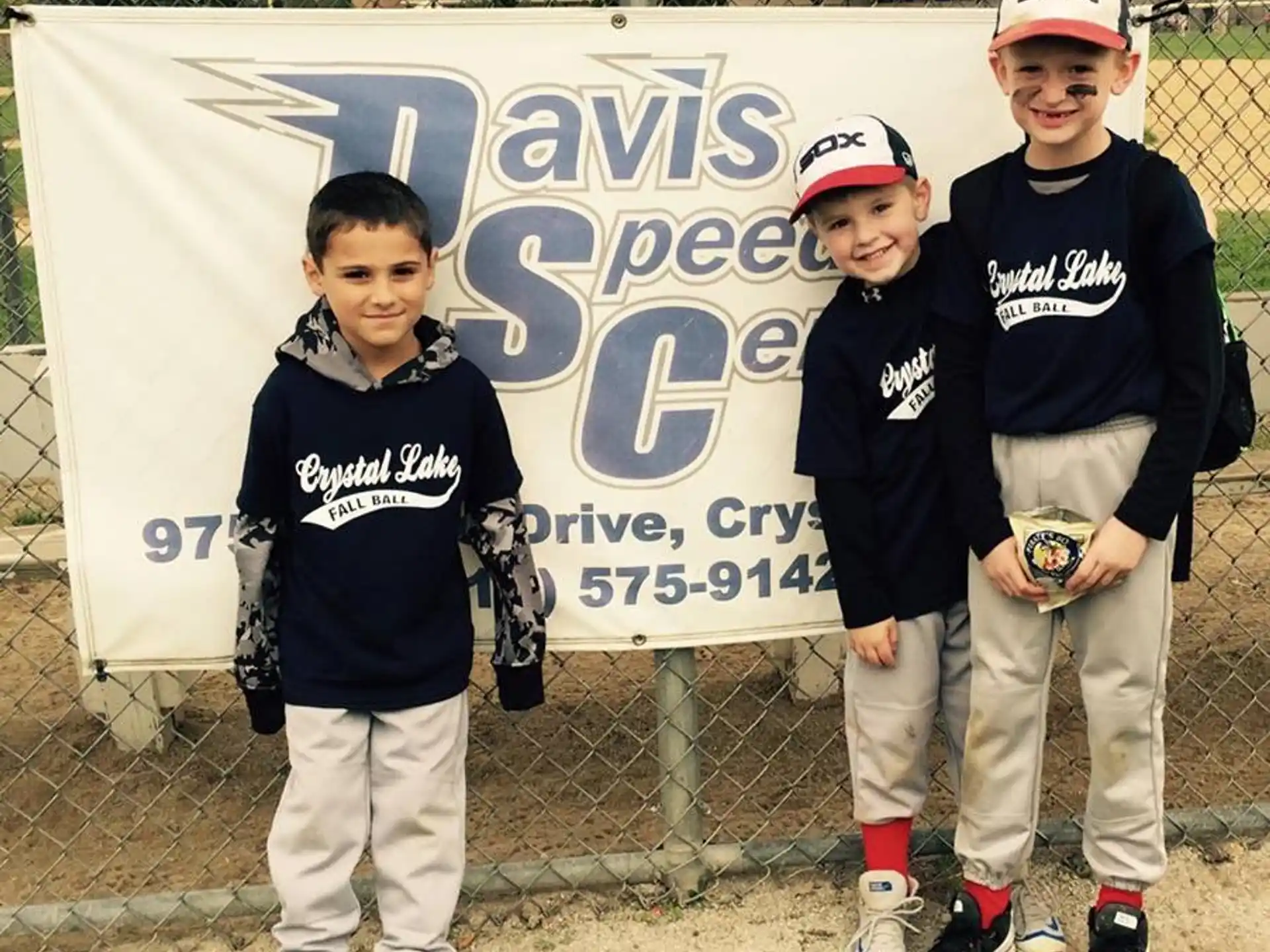 a group of boys posing for a picture in front of a banner