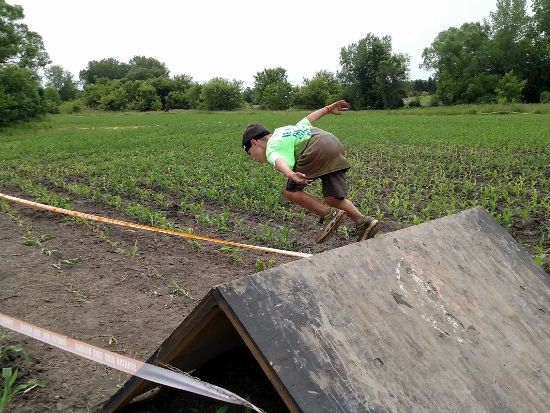a man jumping over a large piece of wood