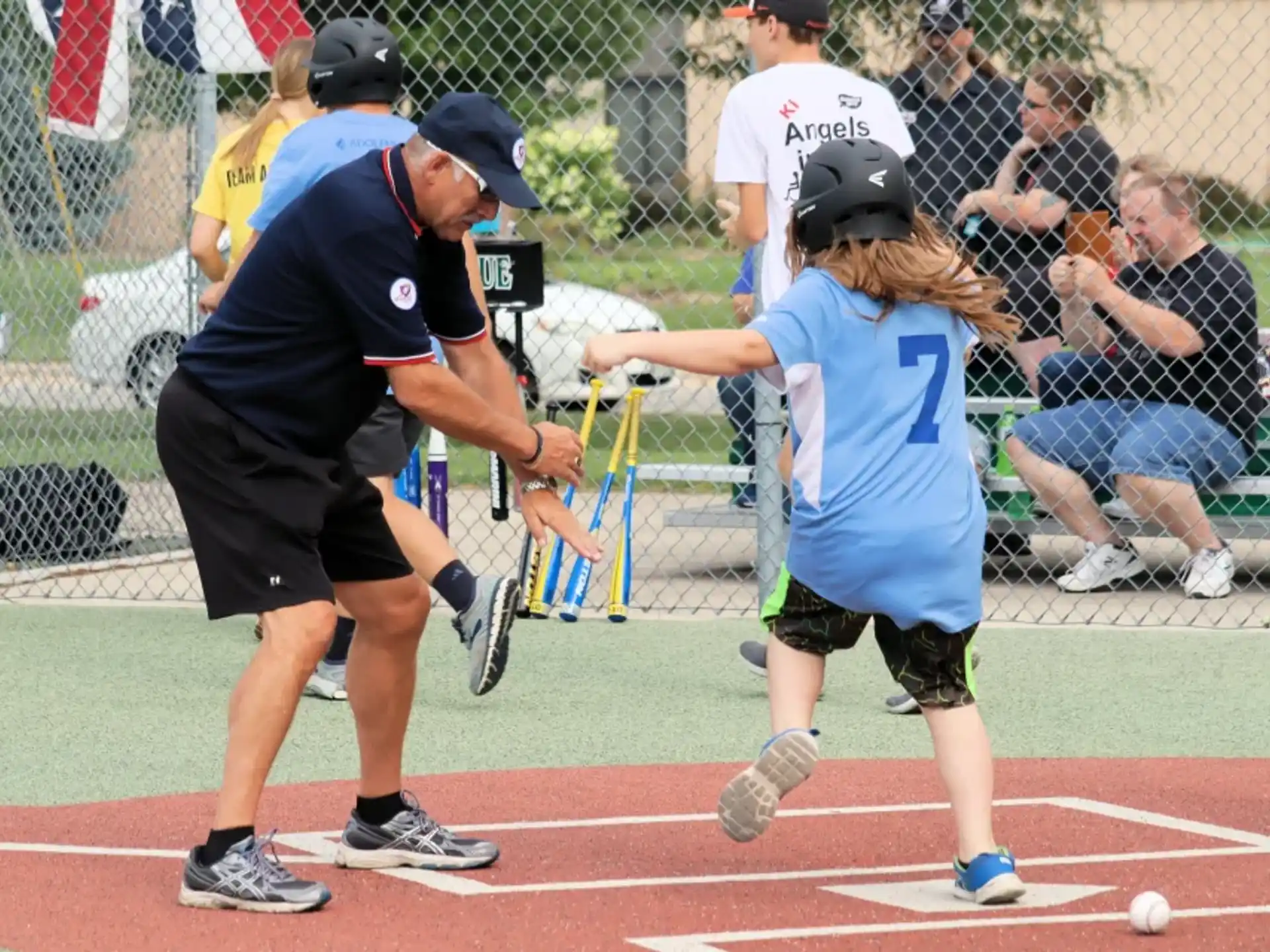 a girl hitting a ball with her bat