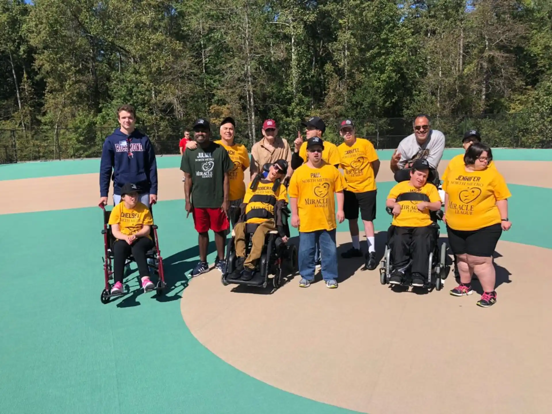 a group of people wearing yellow shirts and standing on a concrete surface