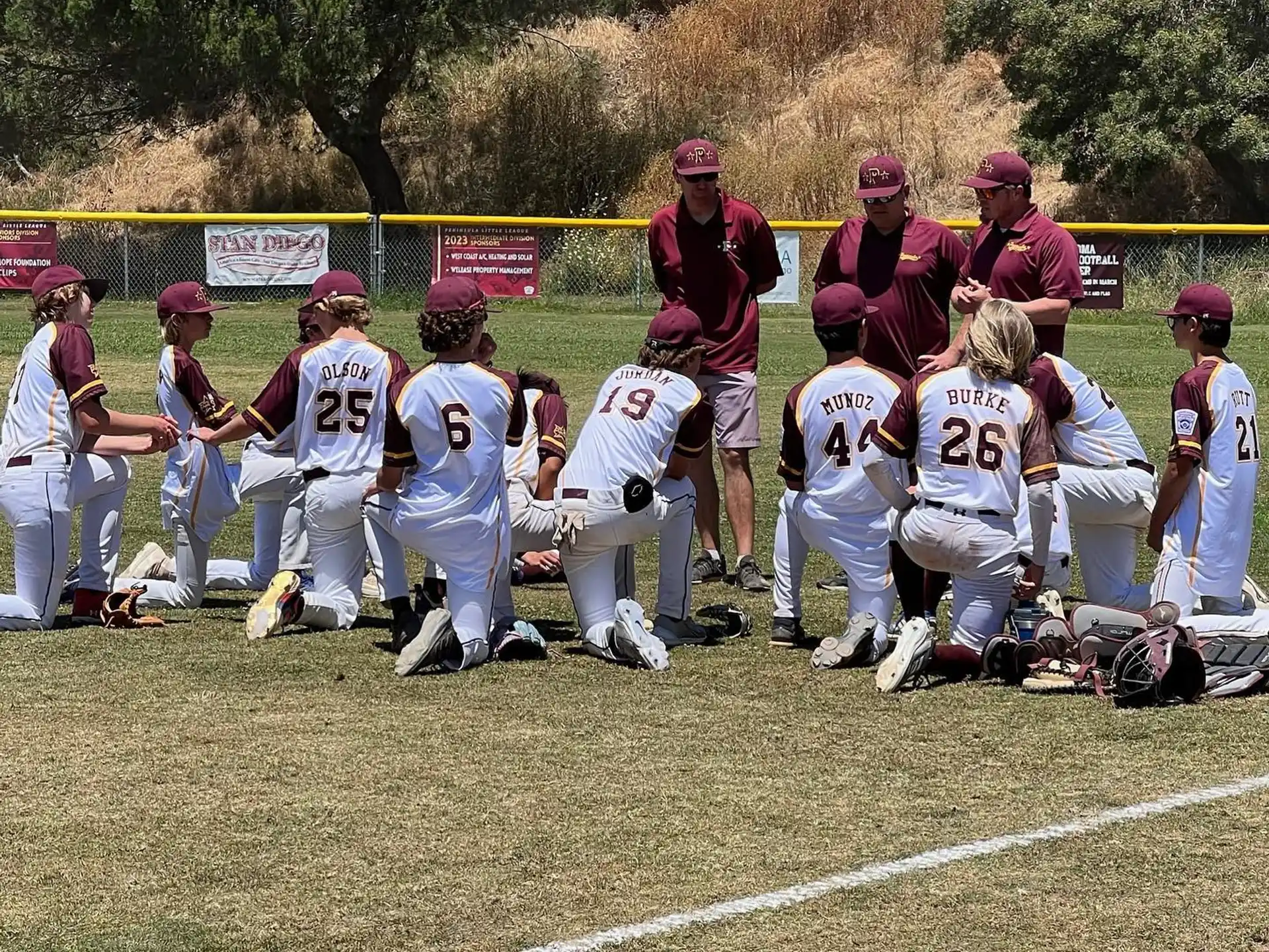 a group of people kneeling on a field