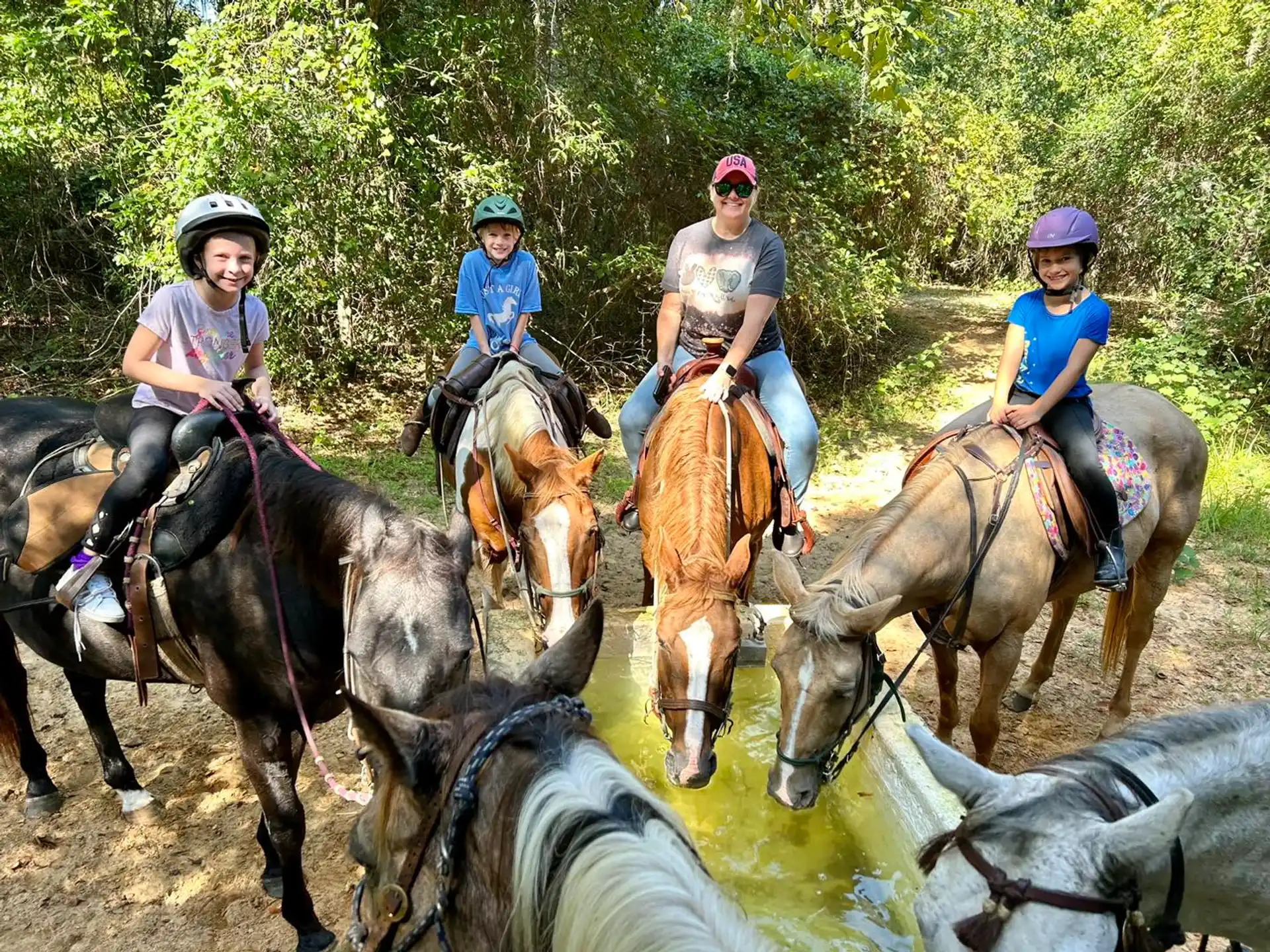 a group of people riding horses