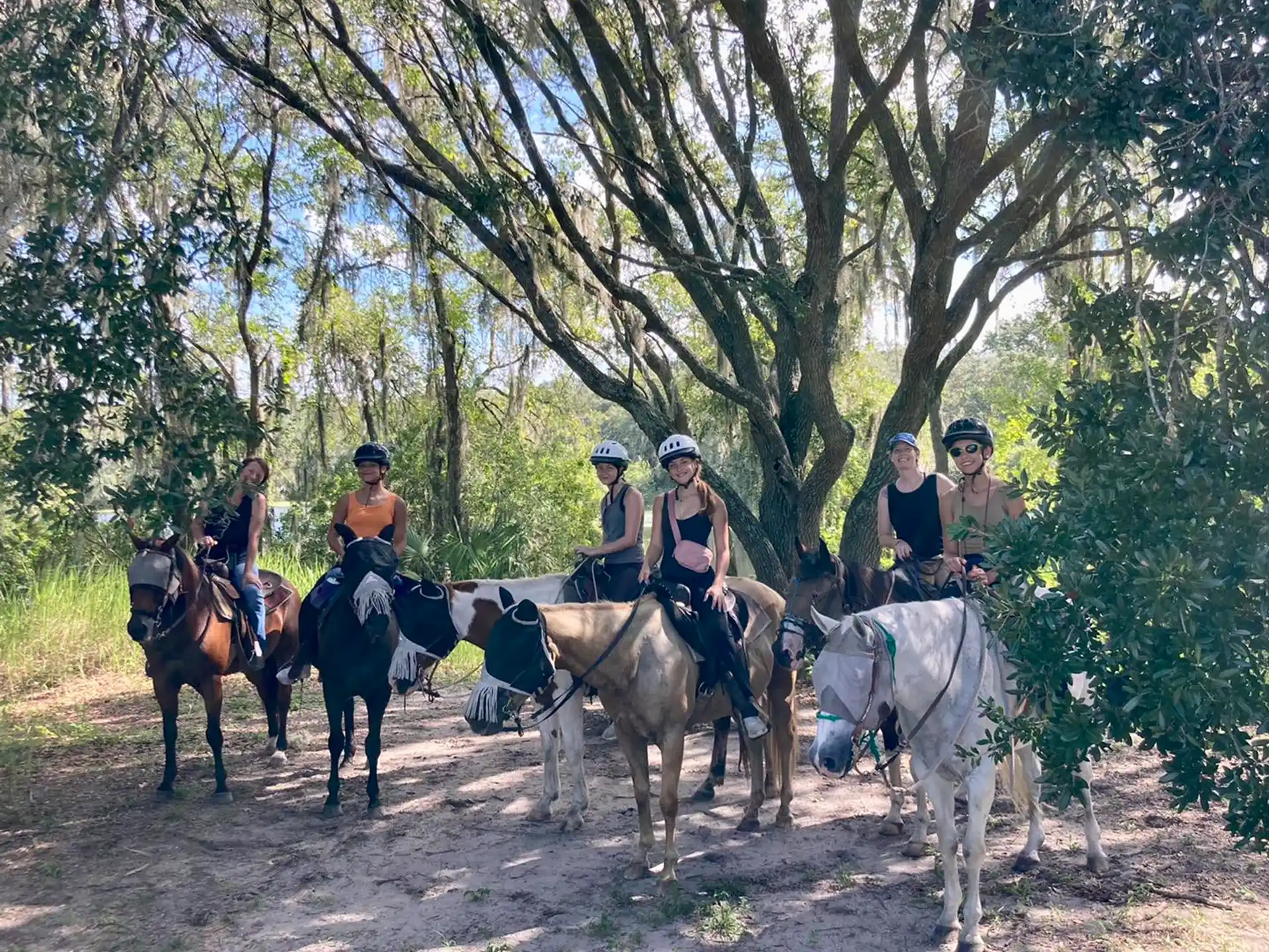 a group of people riding horses