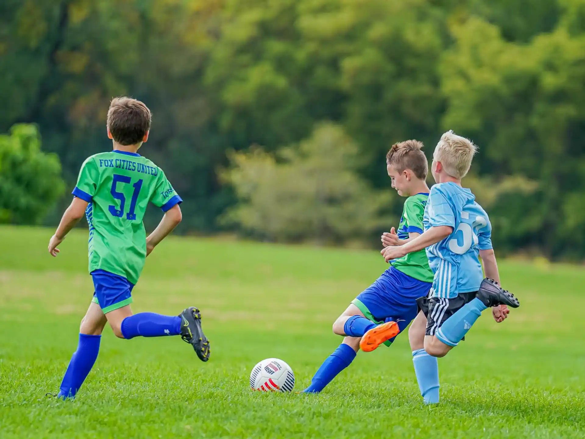 a group of kids playing football