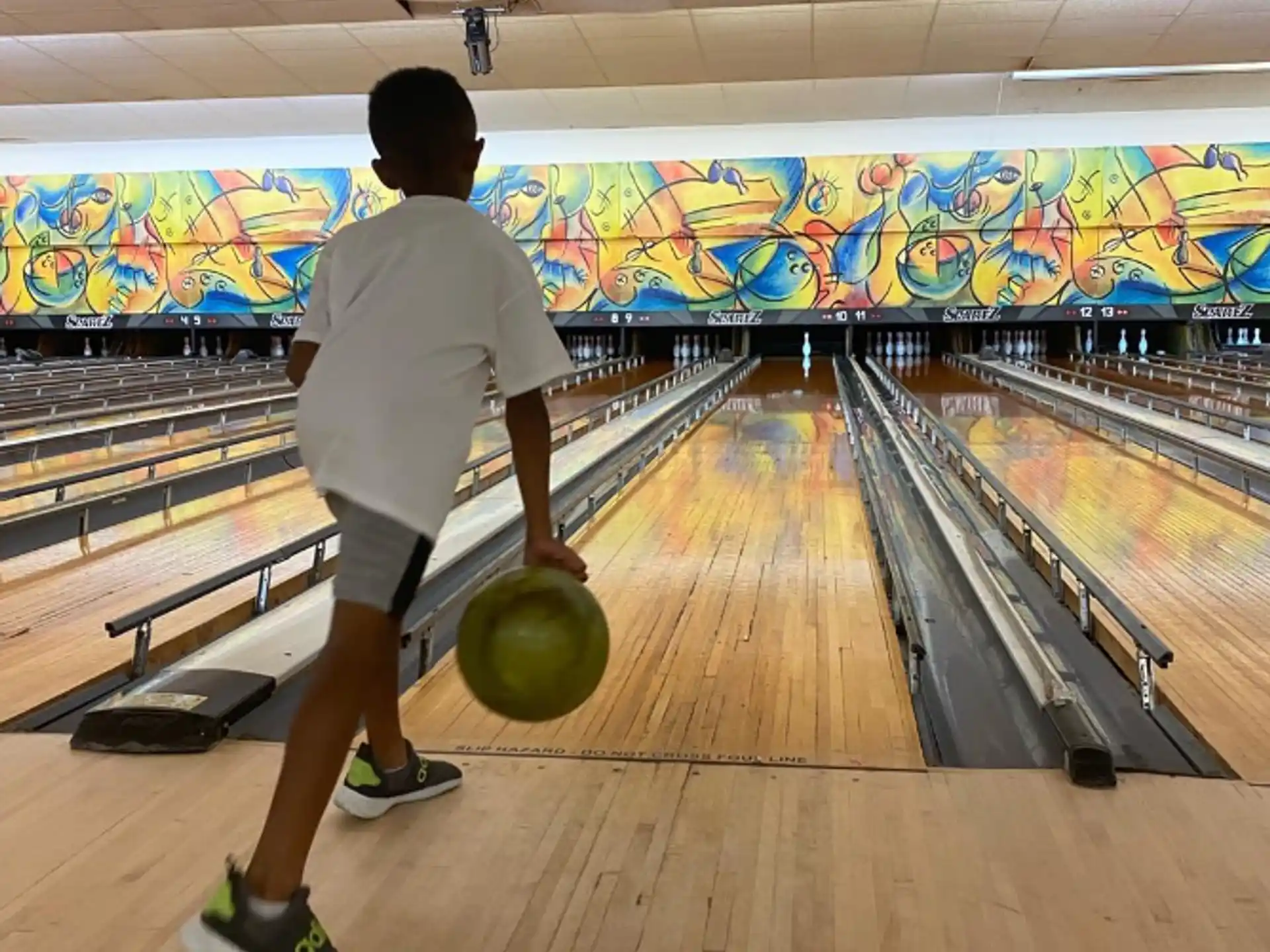 a man bowling in a bowling alley