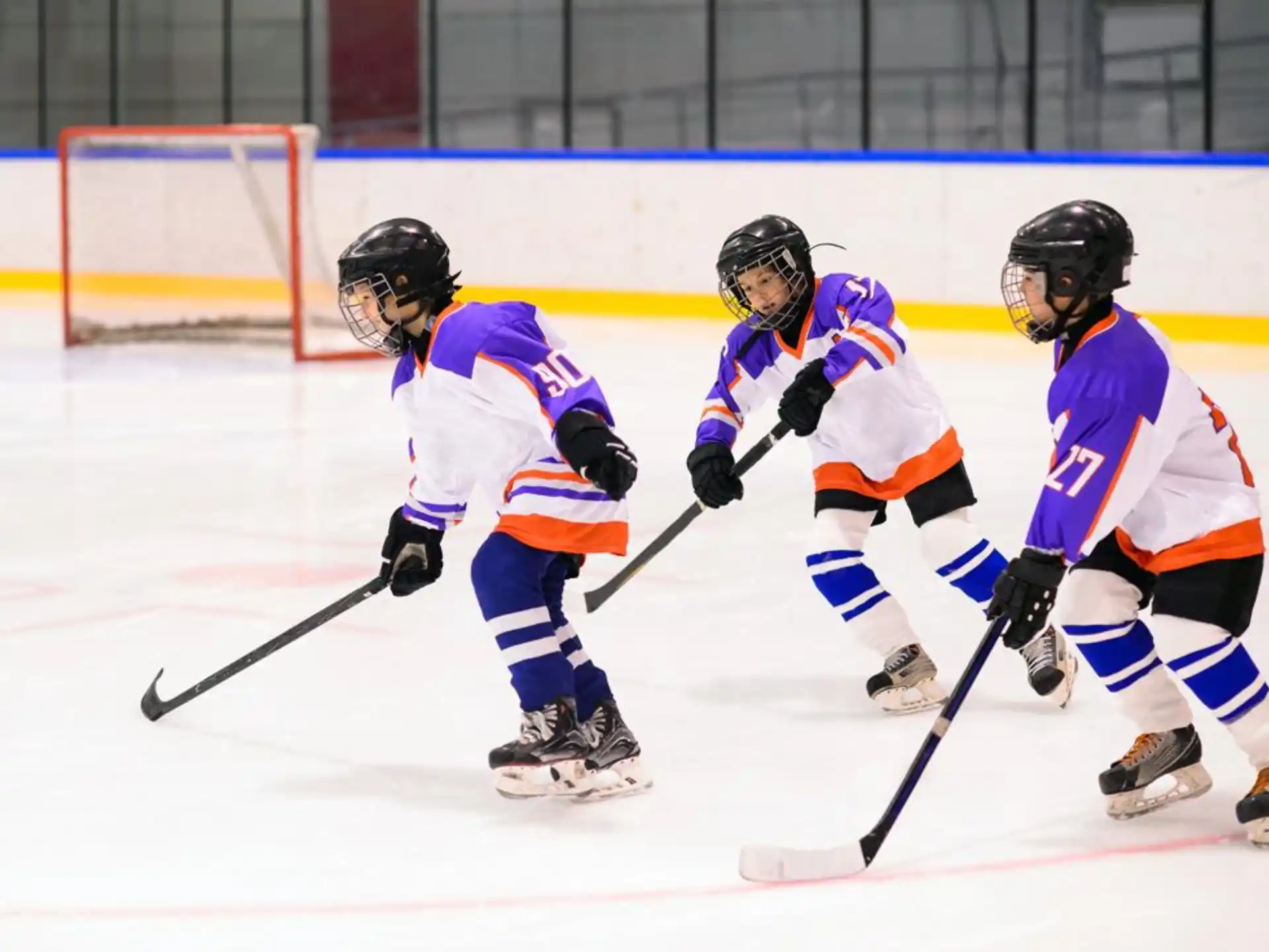 a group of people playing hockey