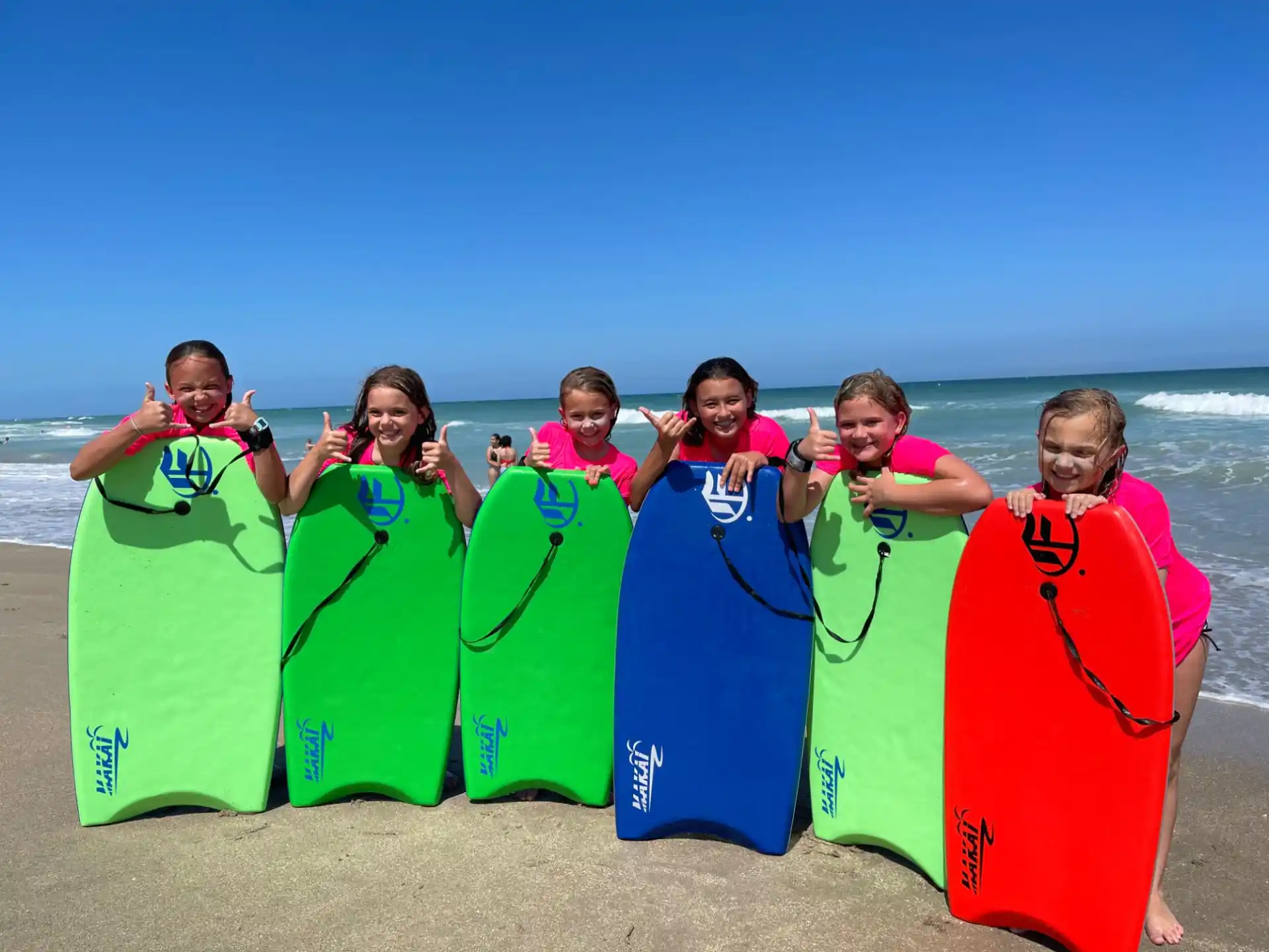 a group of people holding surfboards