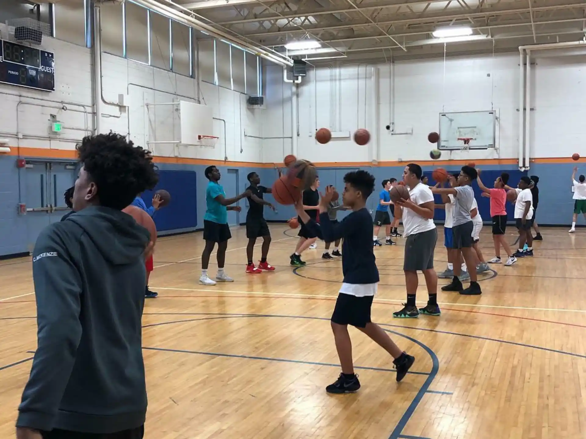 a group of people playing basketball