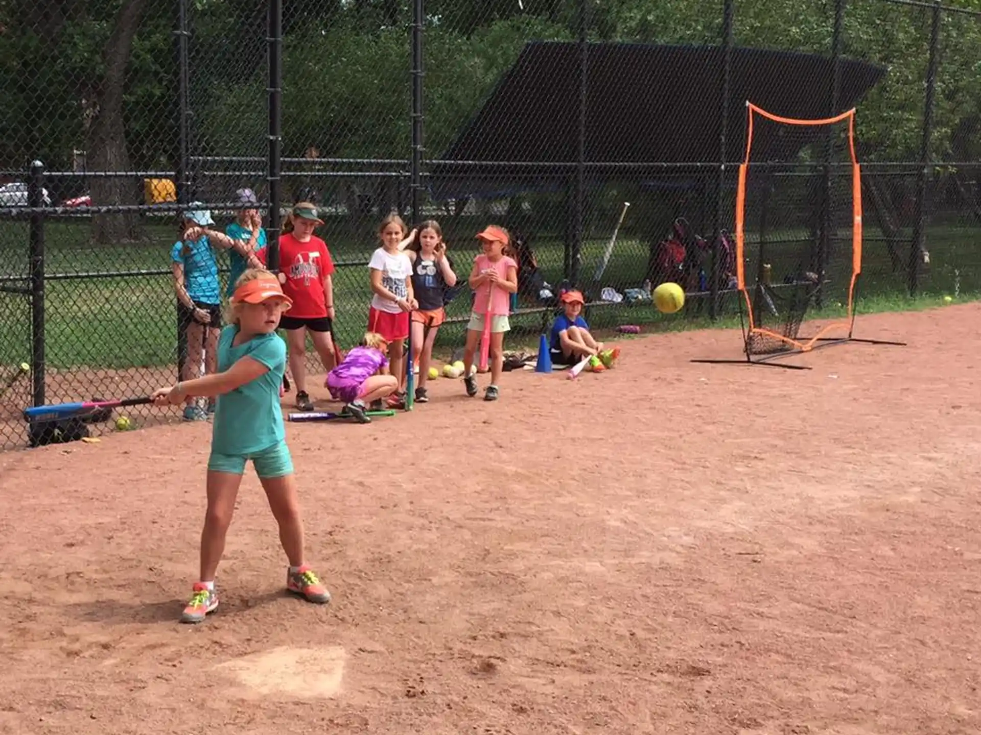 a group of kids playing baseball