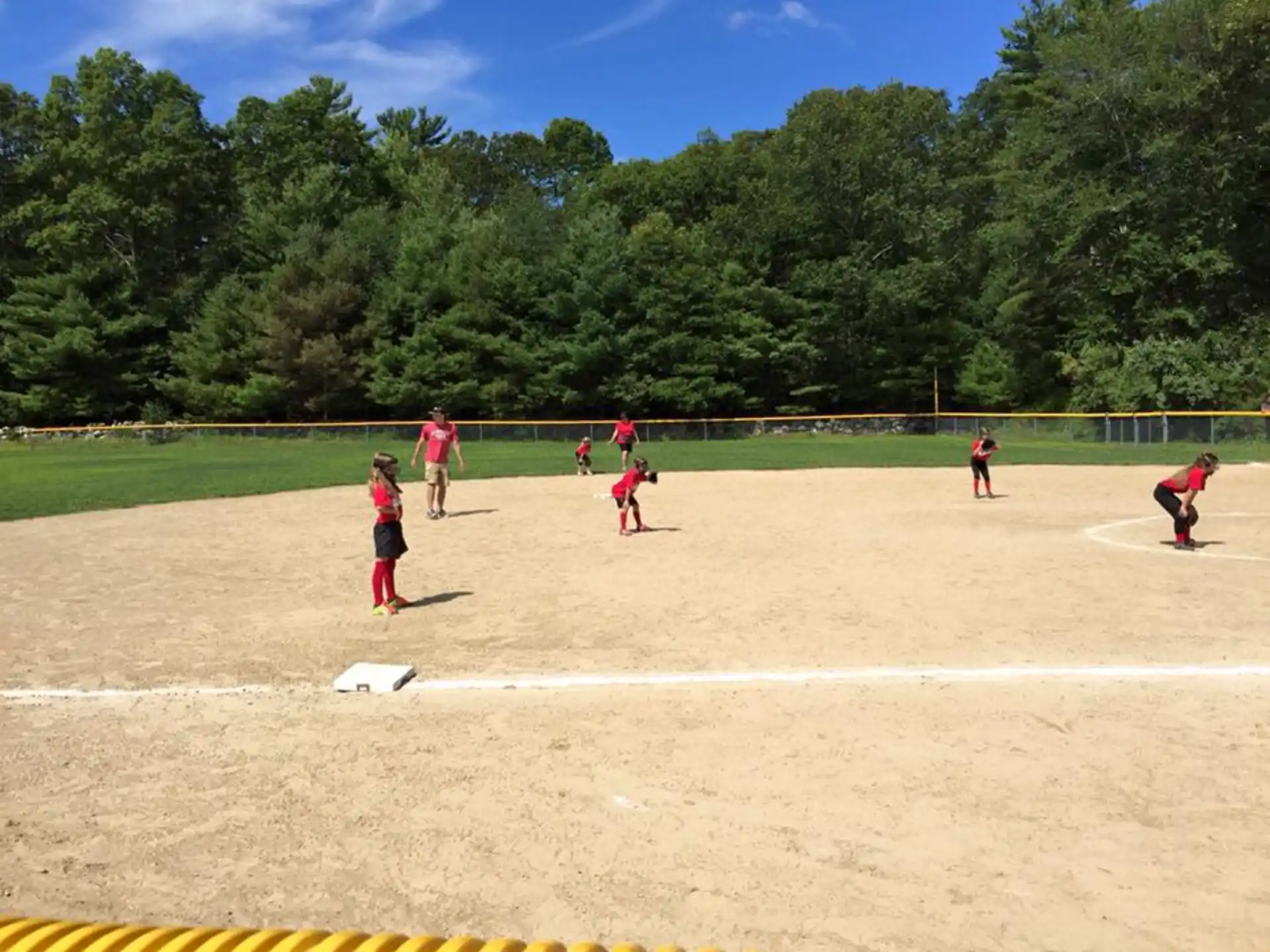 a group of people playing baseball