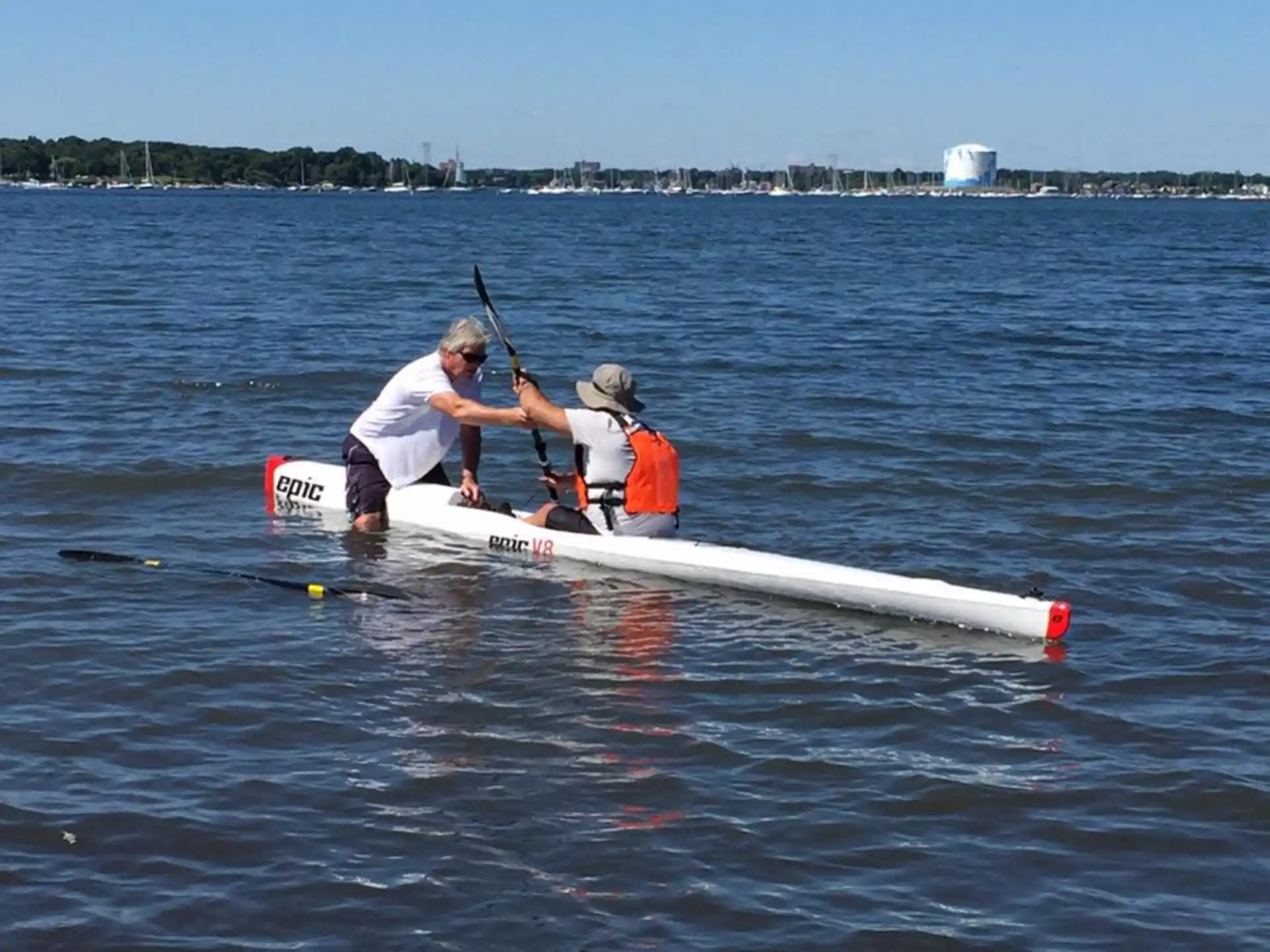 a couple of people rowing a boat