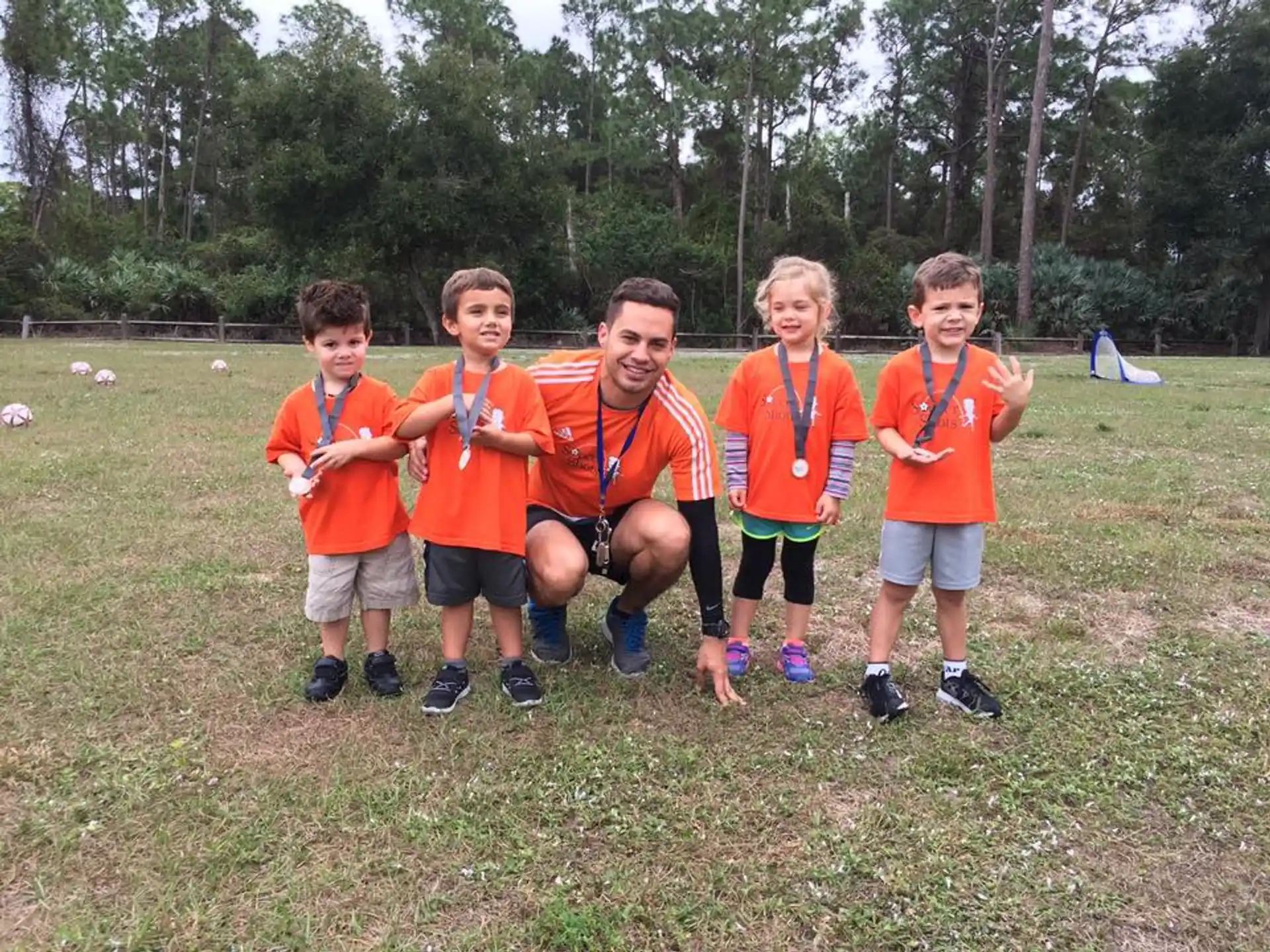 a group of boys wearing orange shirts