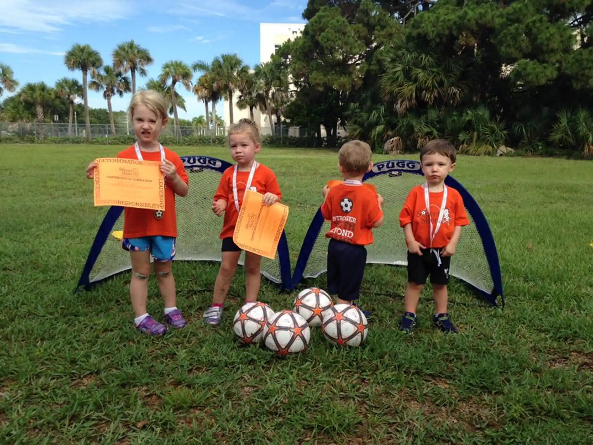 a group of kids with football balls