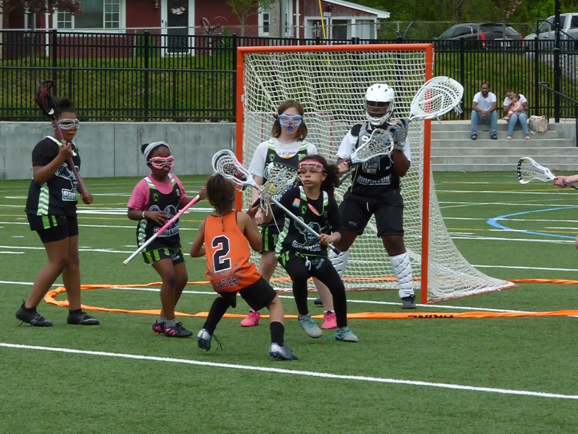 a group of people playing lacrosse