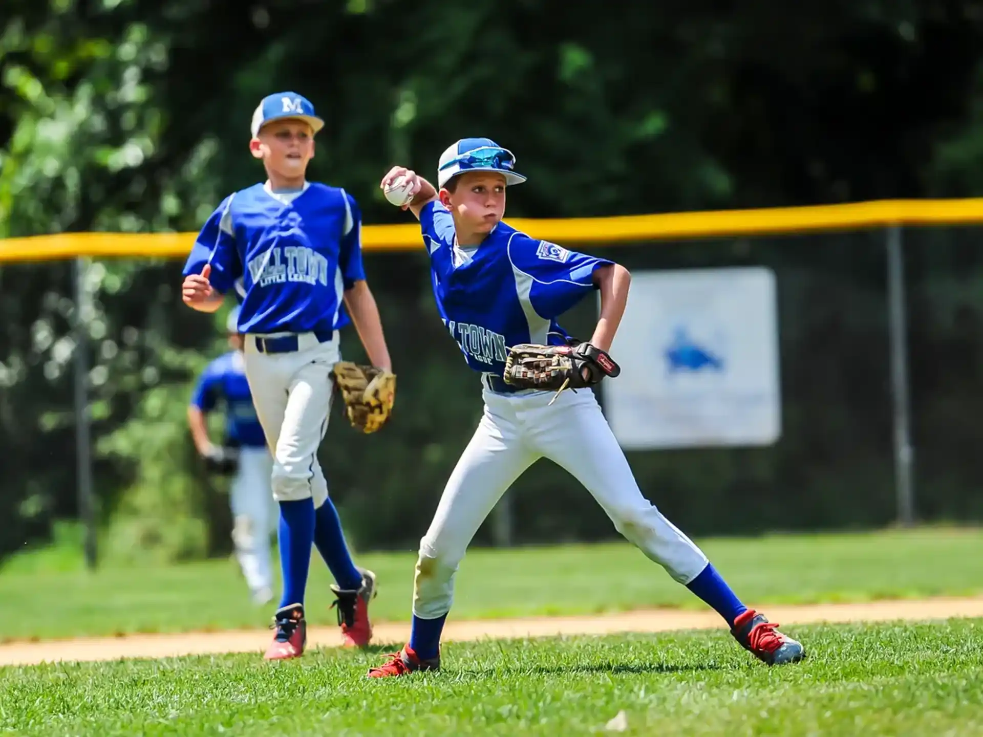 a couple of young boys playing baseball