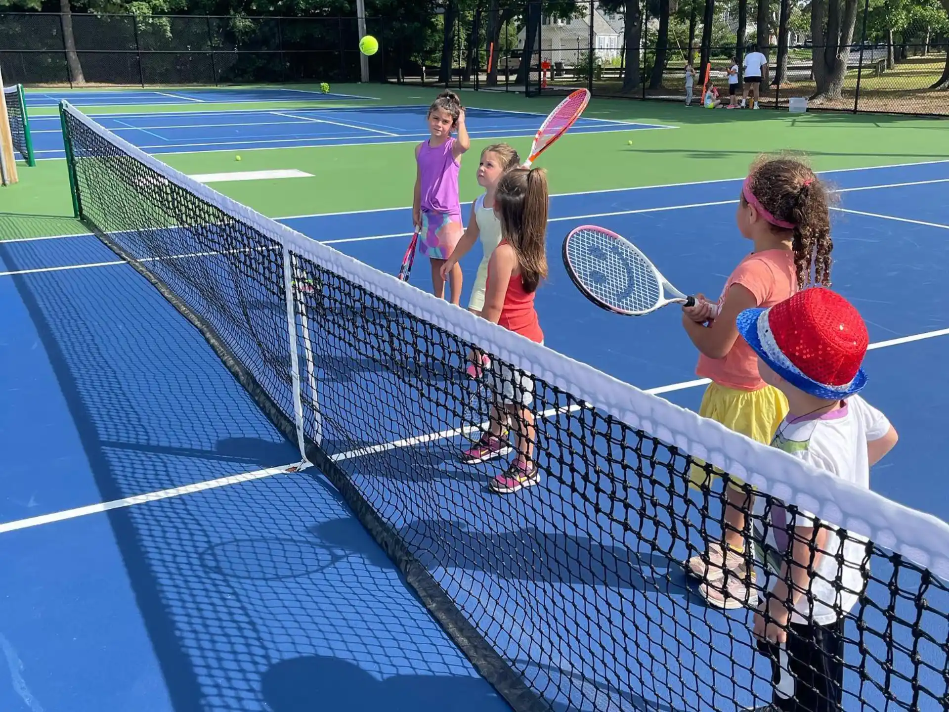 kids playing tennis on a court