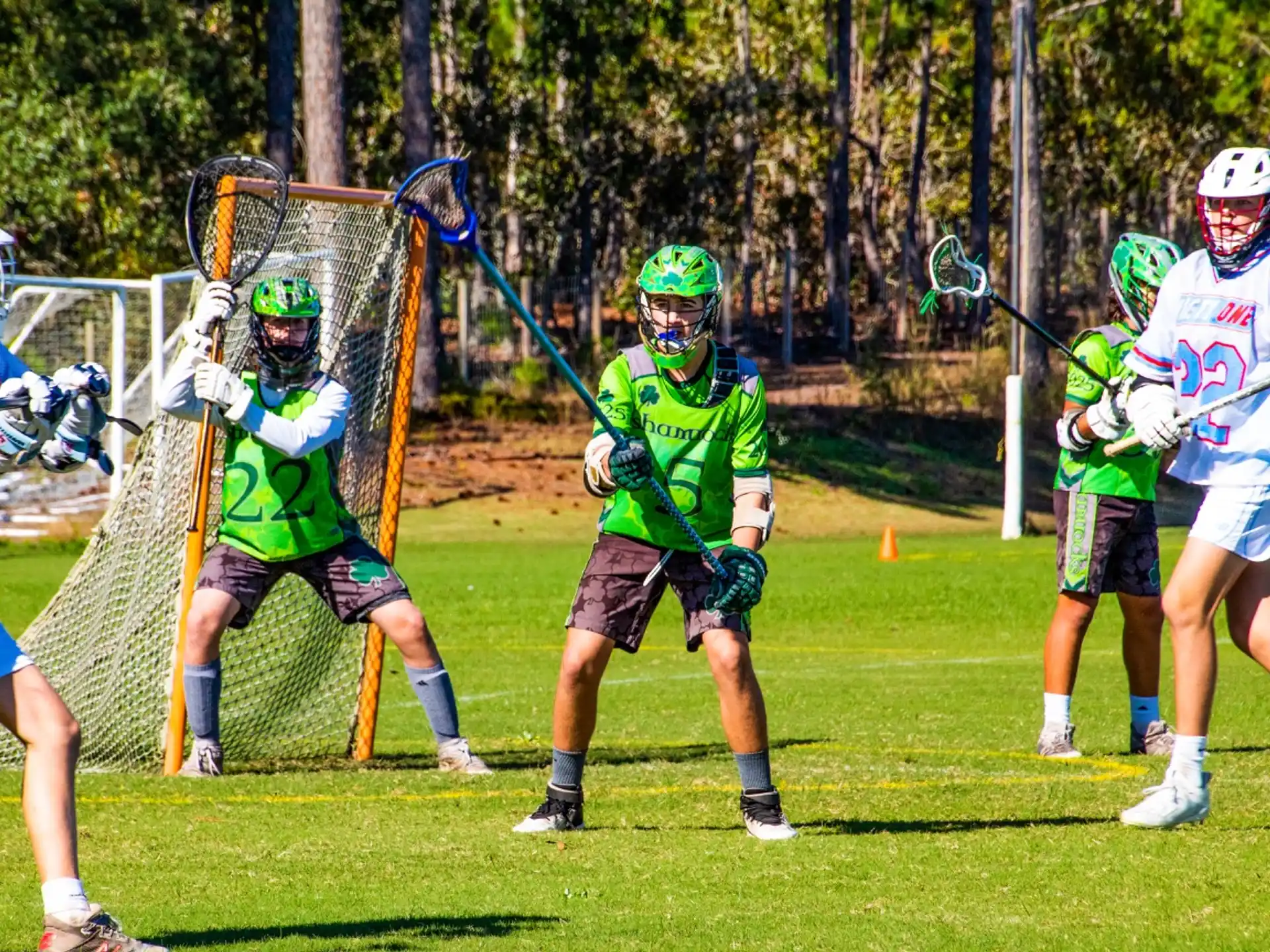 a group of people playing lacrosse